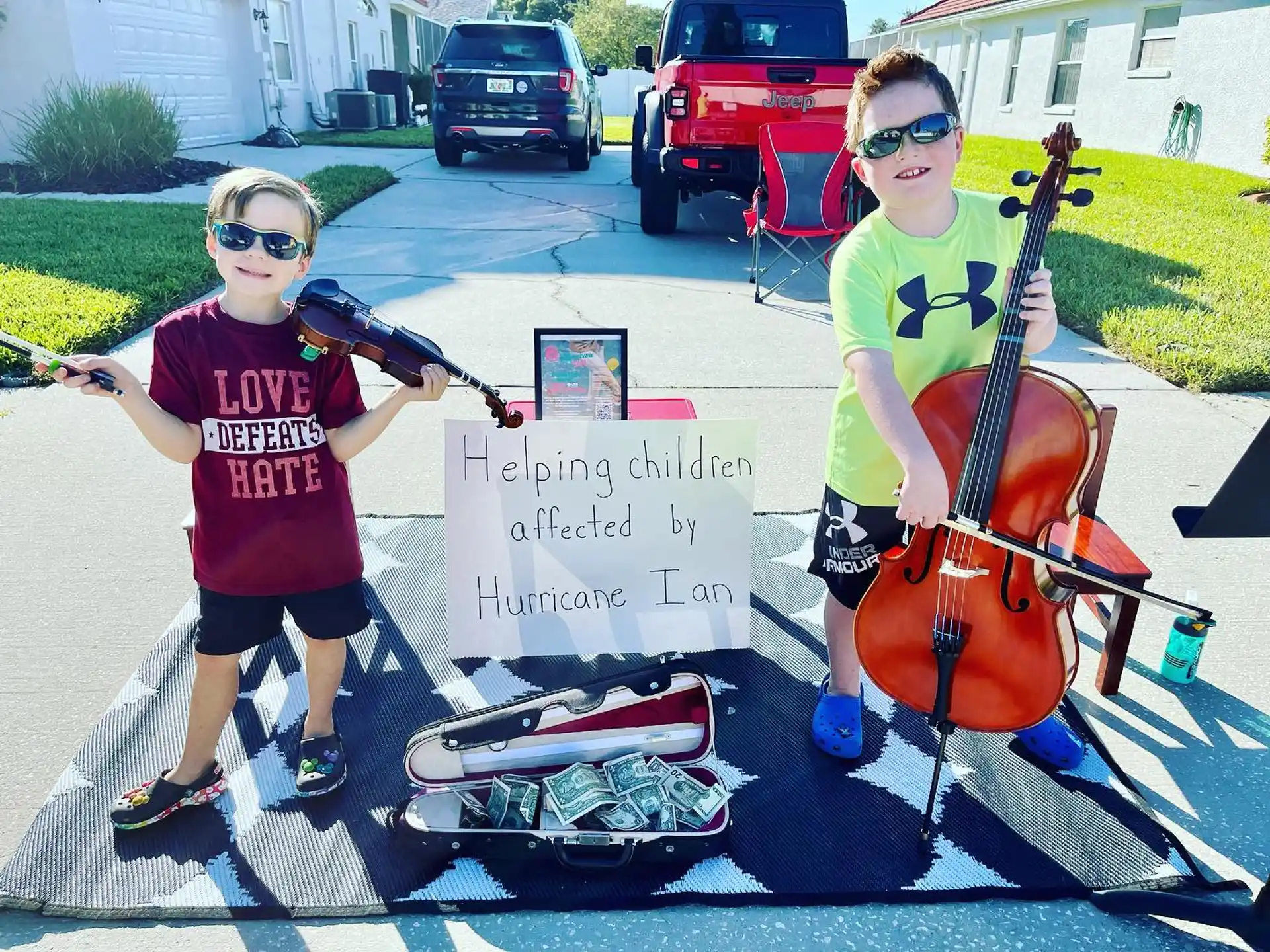 a couple of kids holding musical instruments