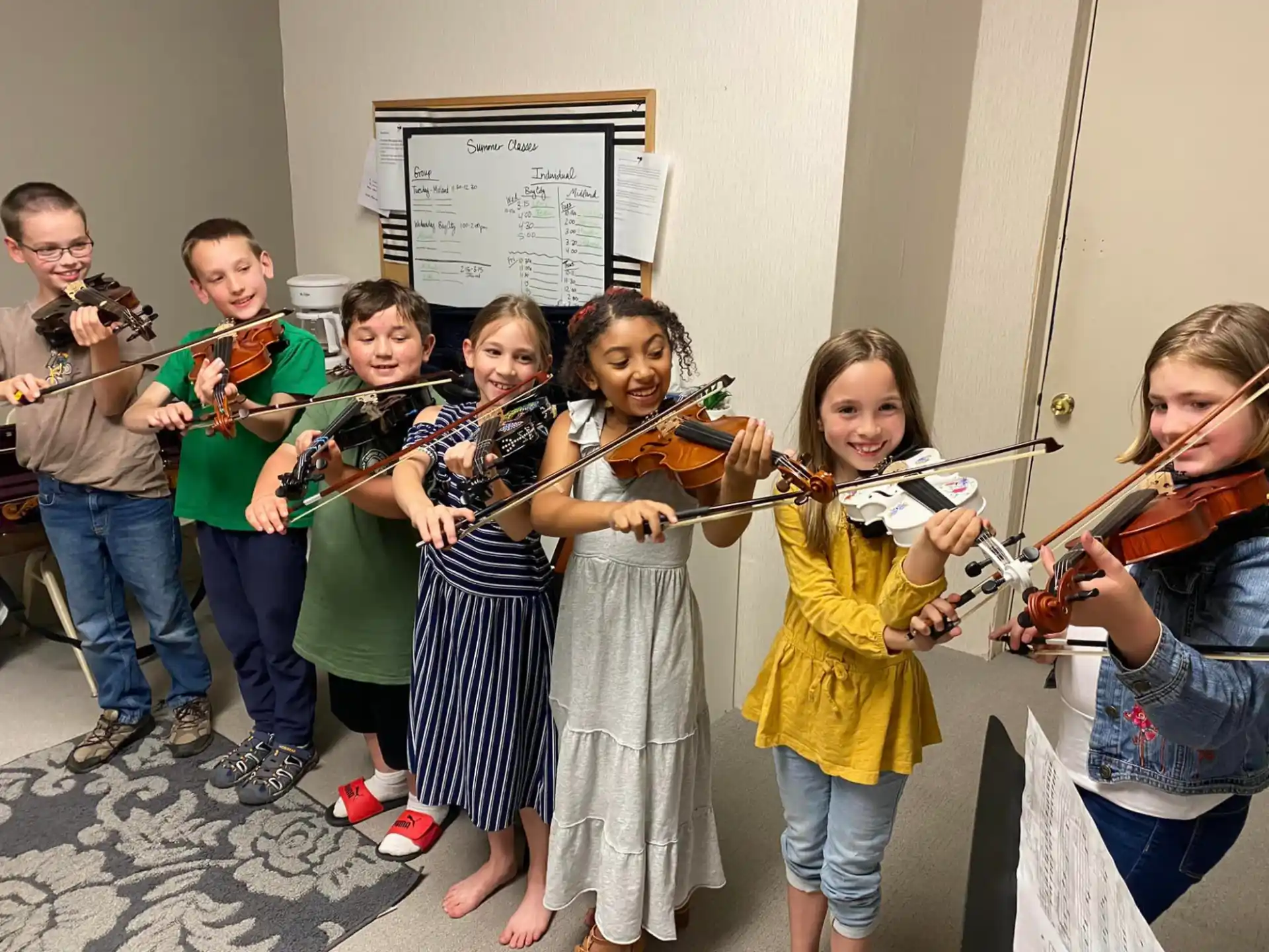 a group of children holding musical instruments