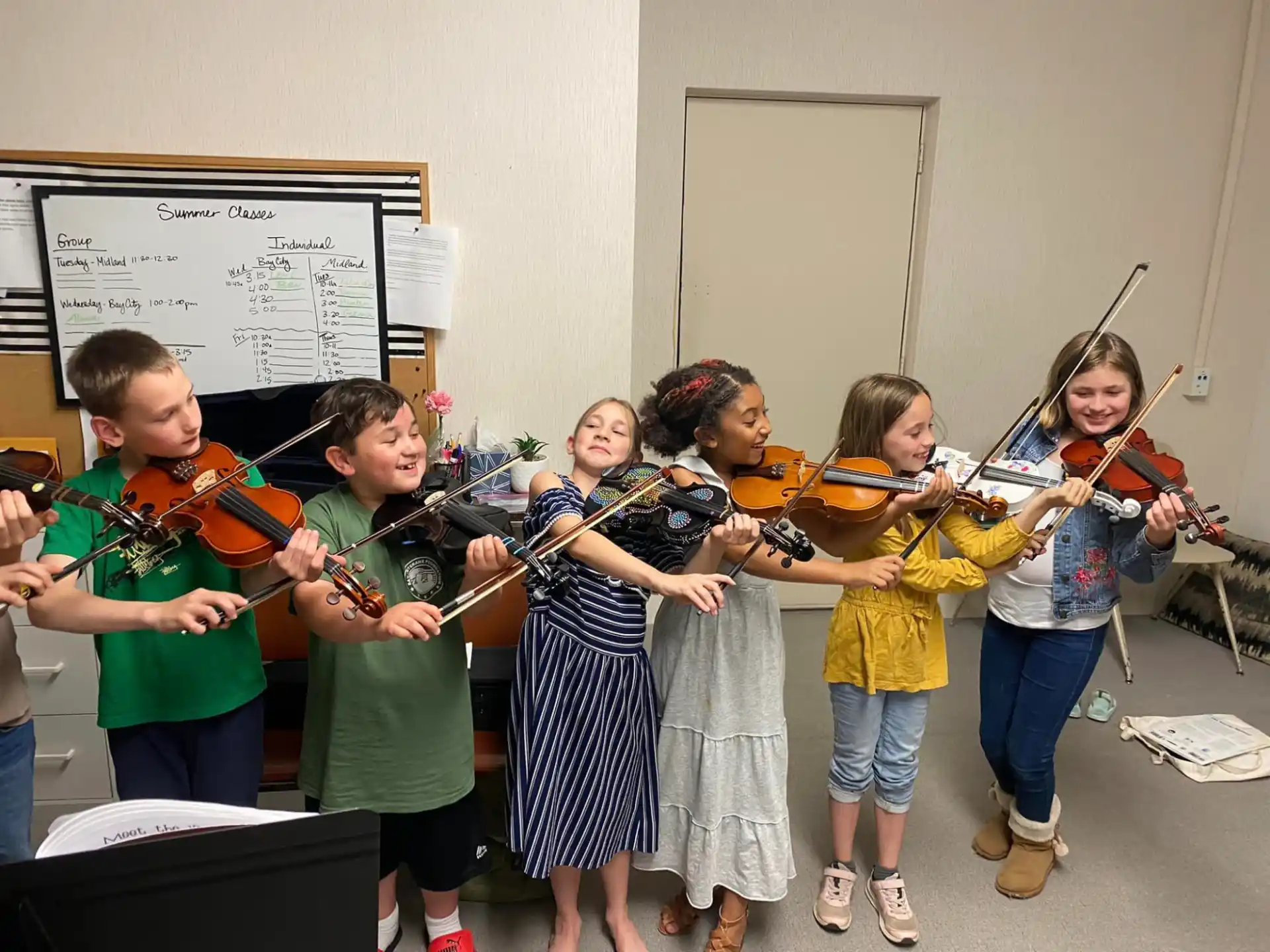 a group of children playing instruments
