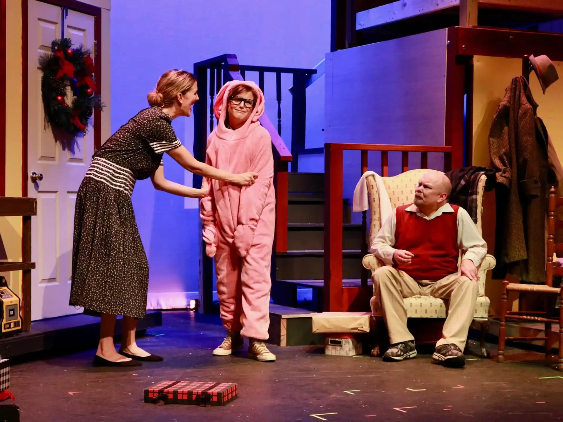 a woman and a man in a room with a man in a chair