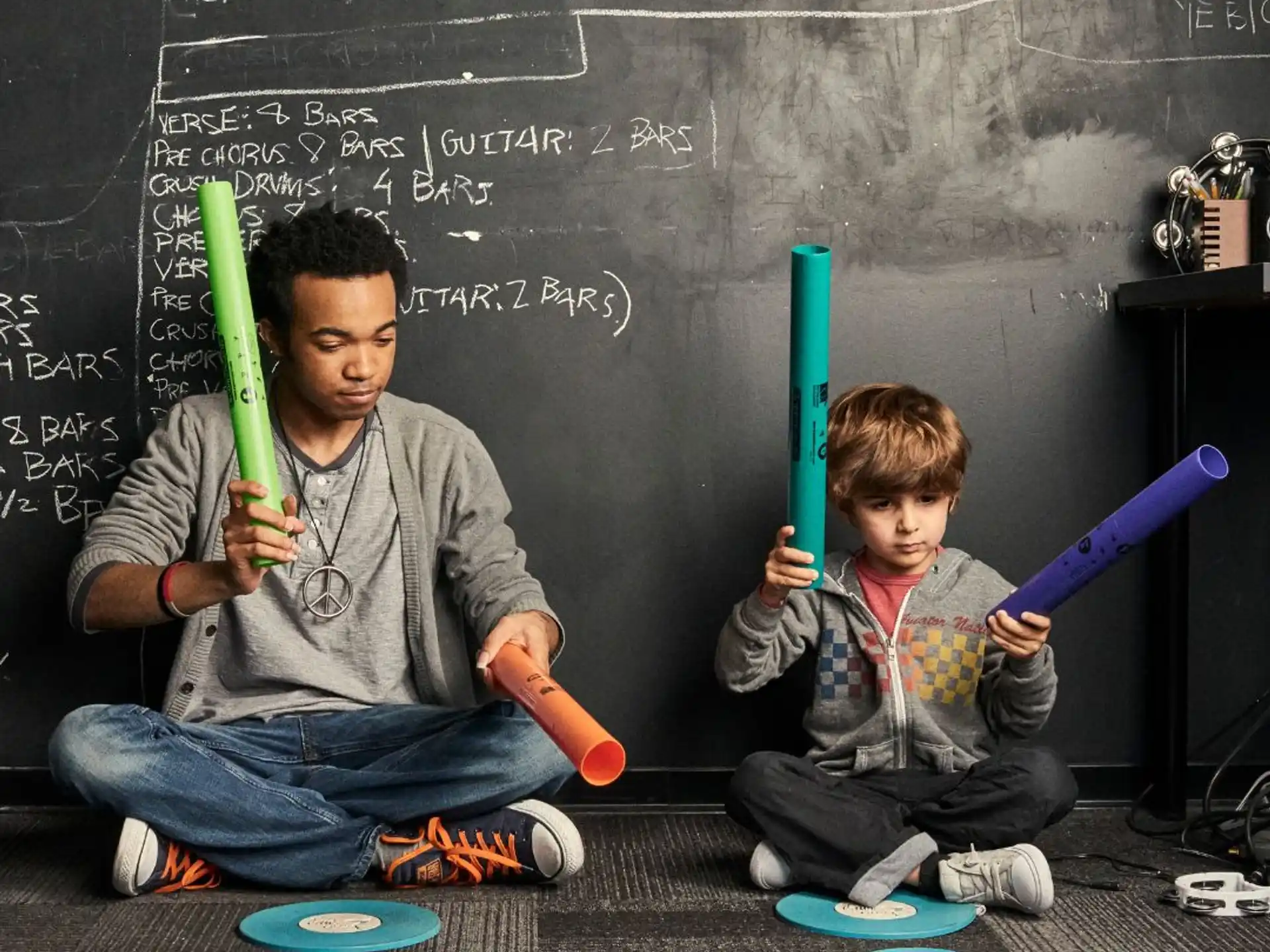 a person and a boy holding baseball bats