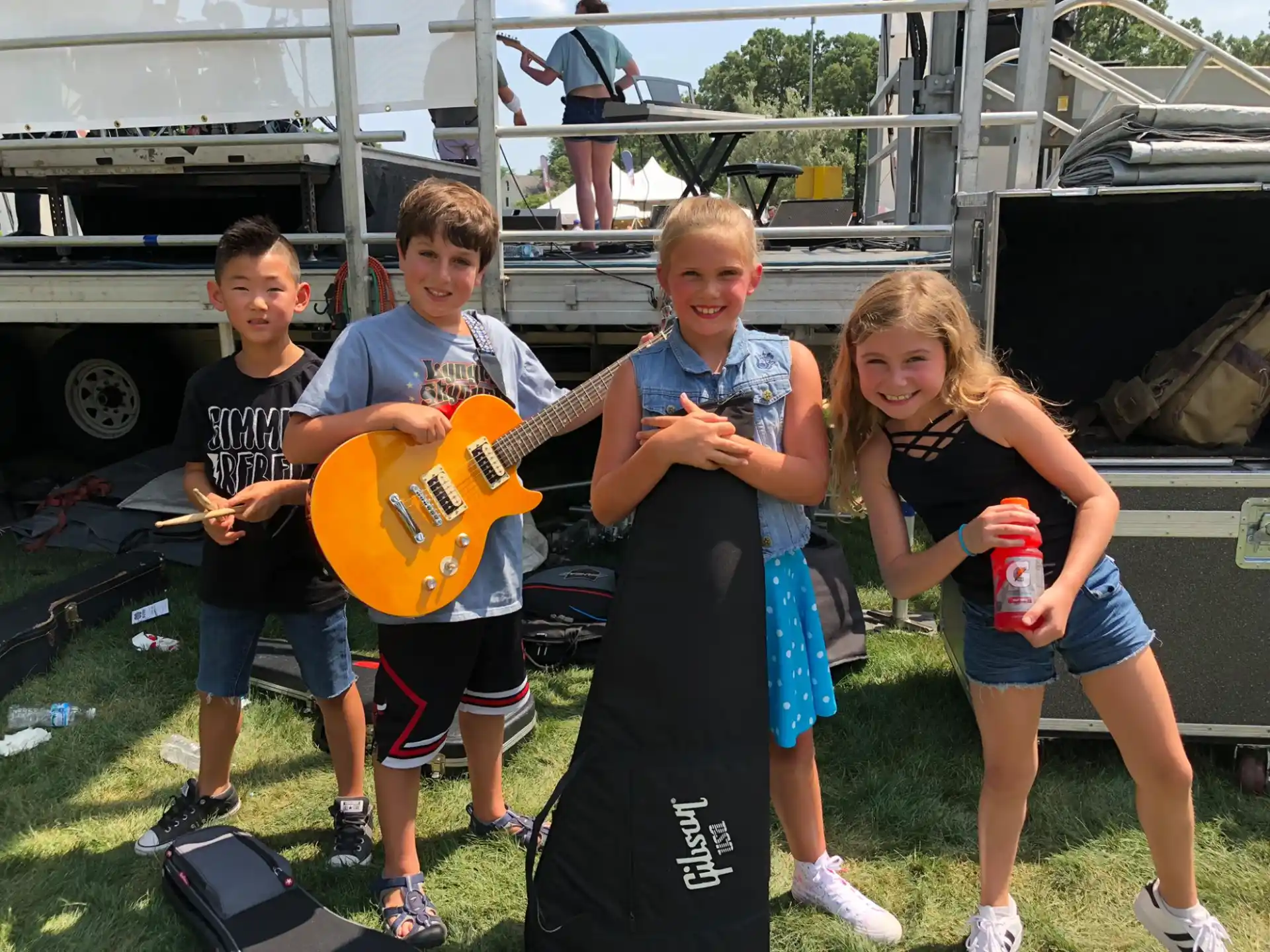 a group of kids holding a guitar