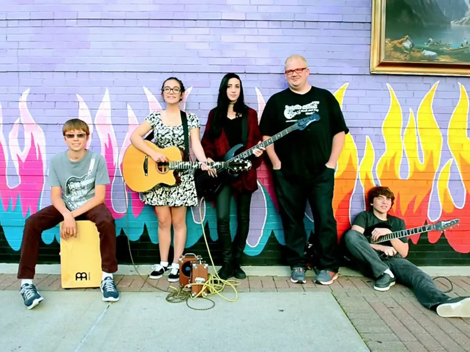 a group of people posing for a photo with guitars