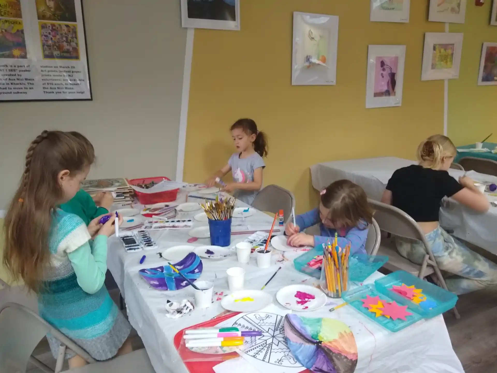 a group of children sitting around a table