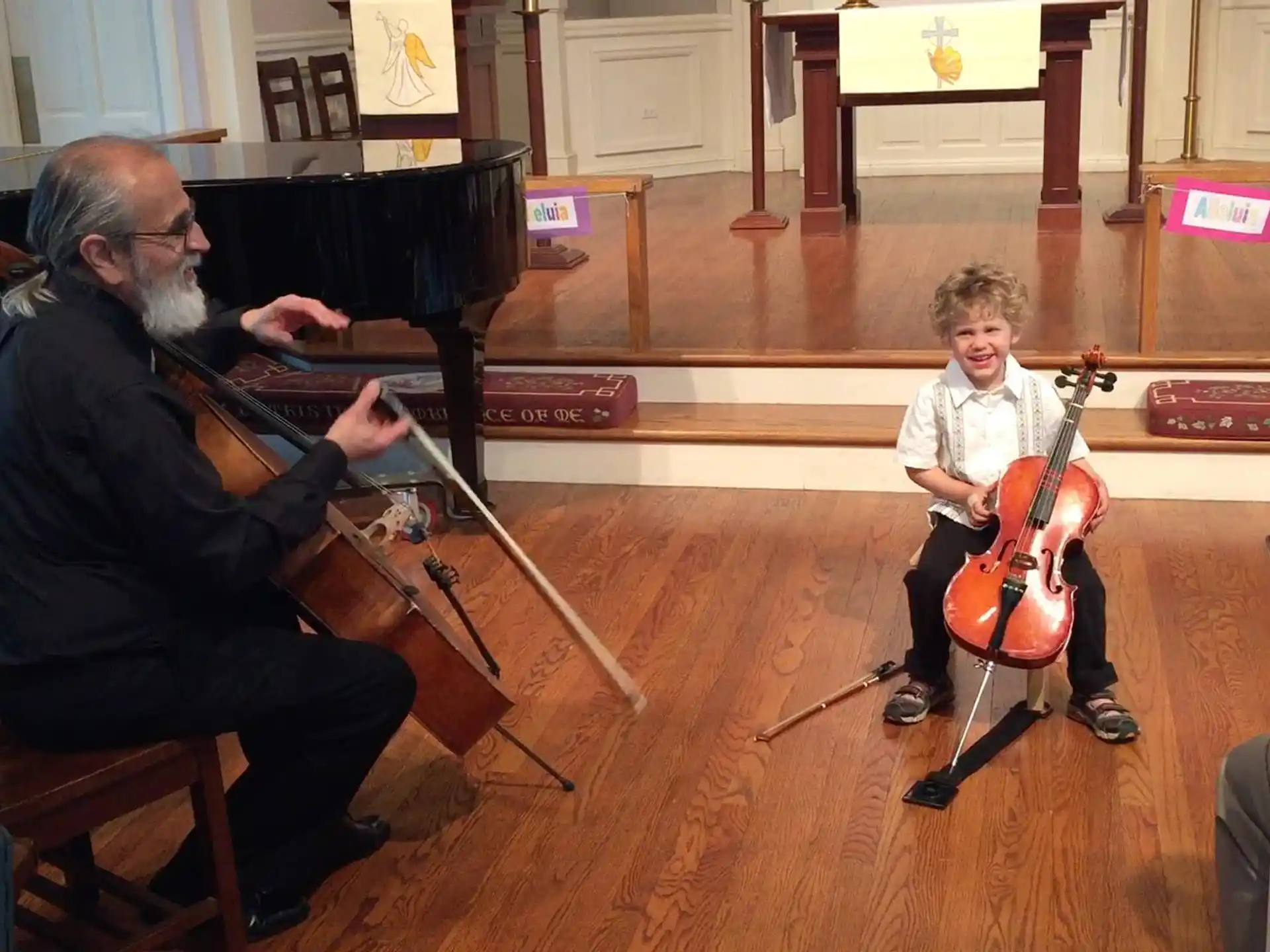 a person and a boy playing the violin
