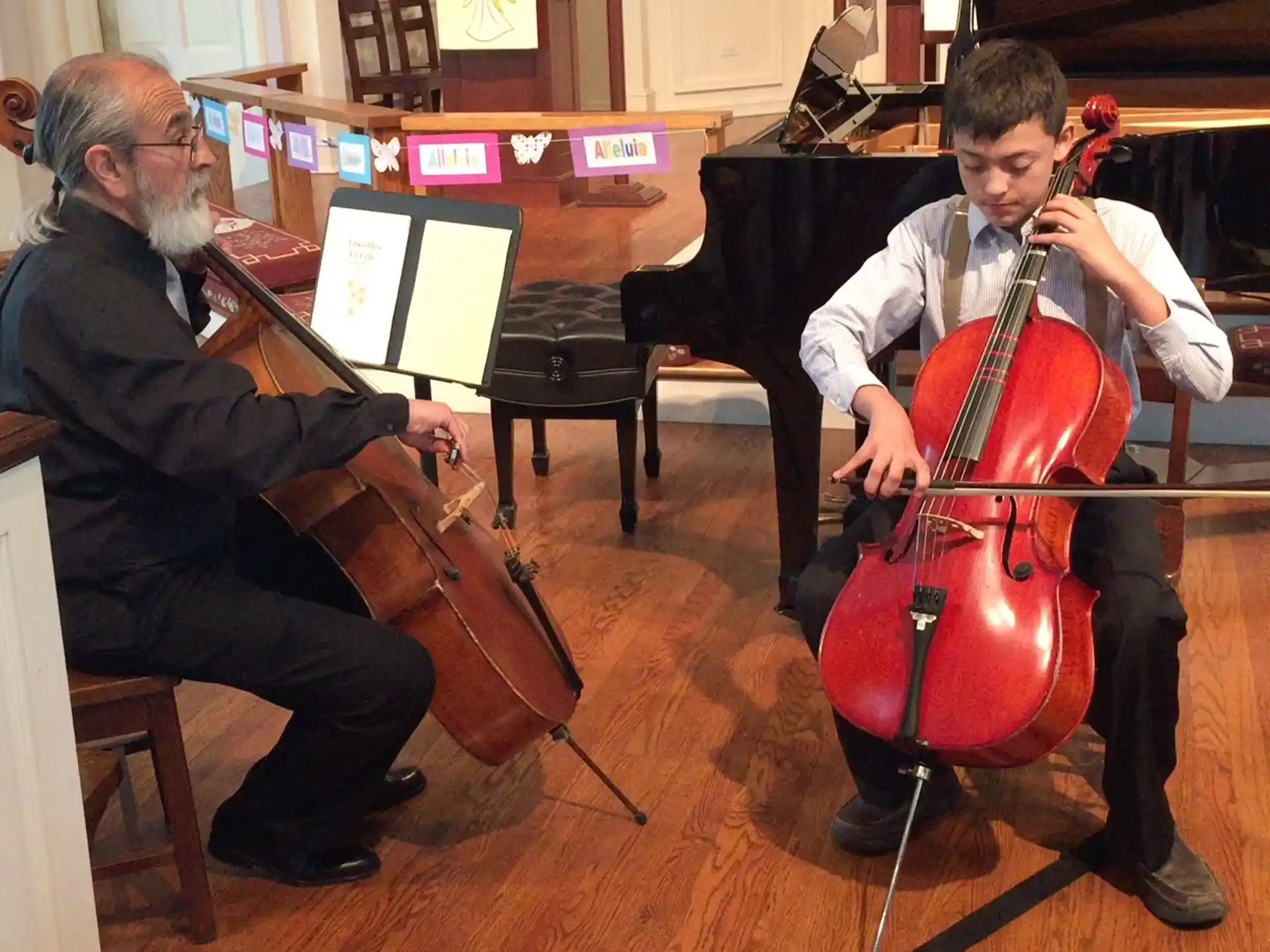 a person playing a cello next to a person playing a violin