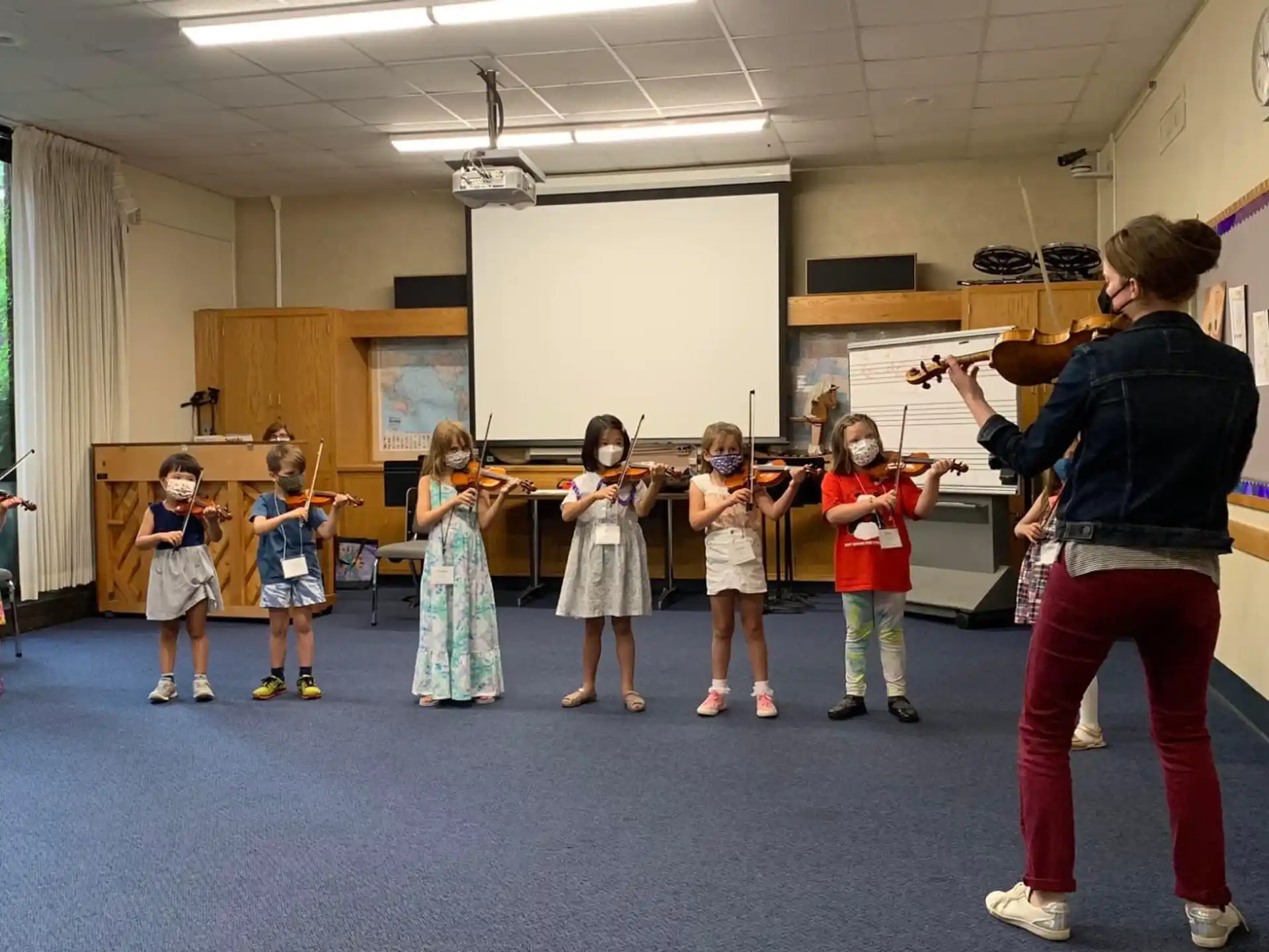 a person teaching children in a classroom