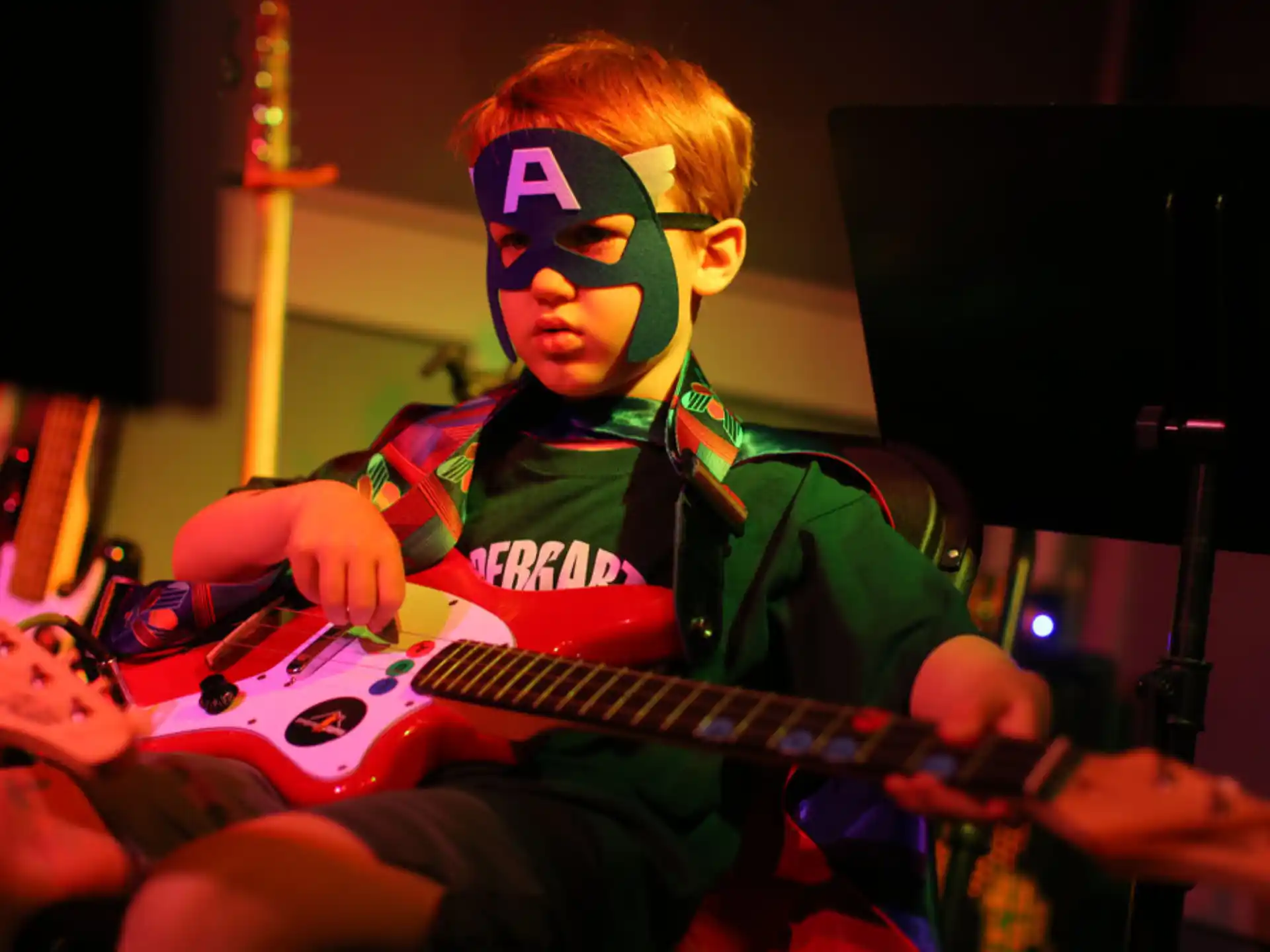 a boy playing a guitar