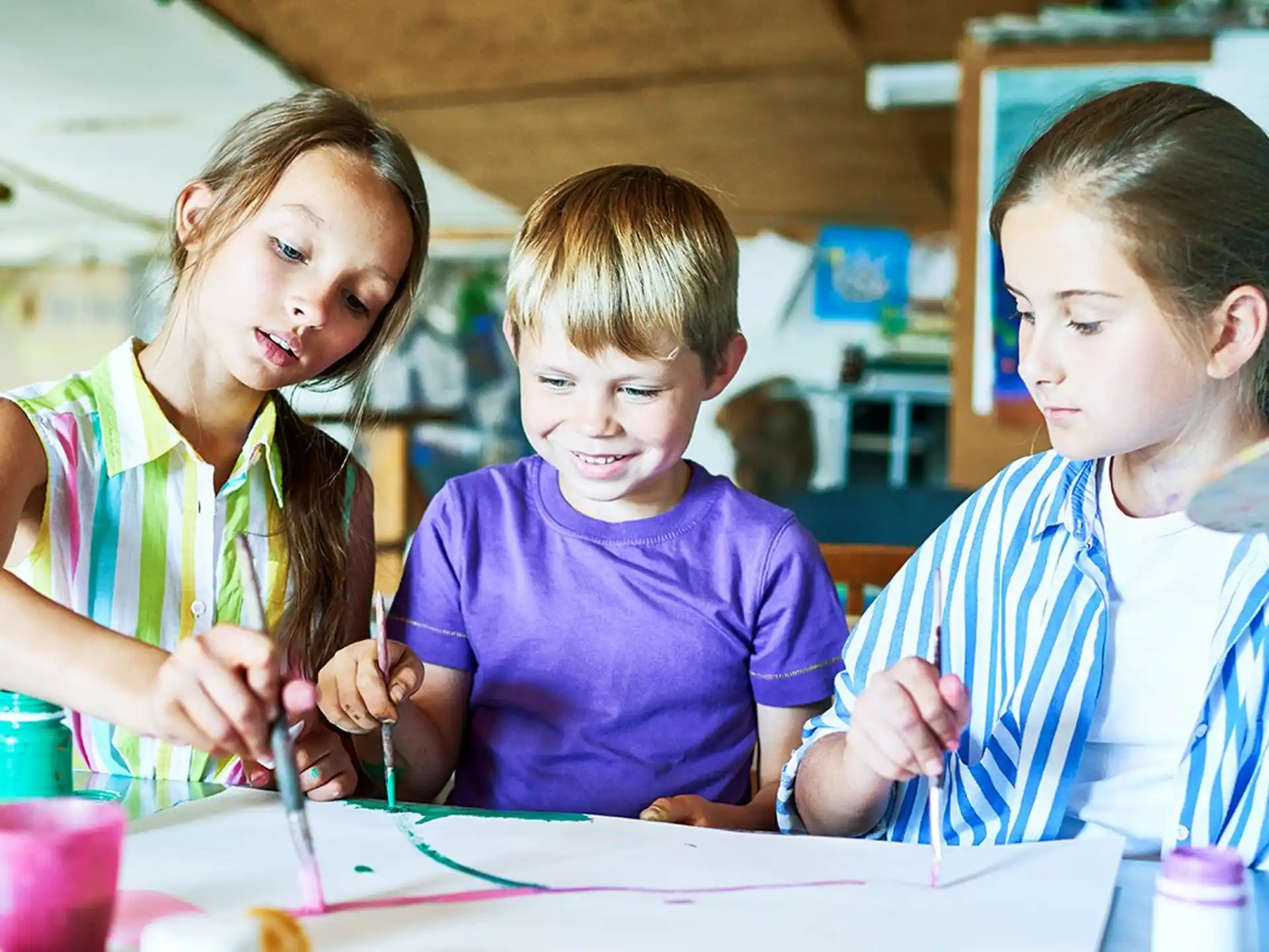 a few children sitting at a table