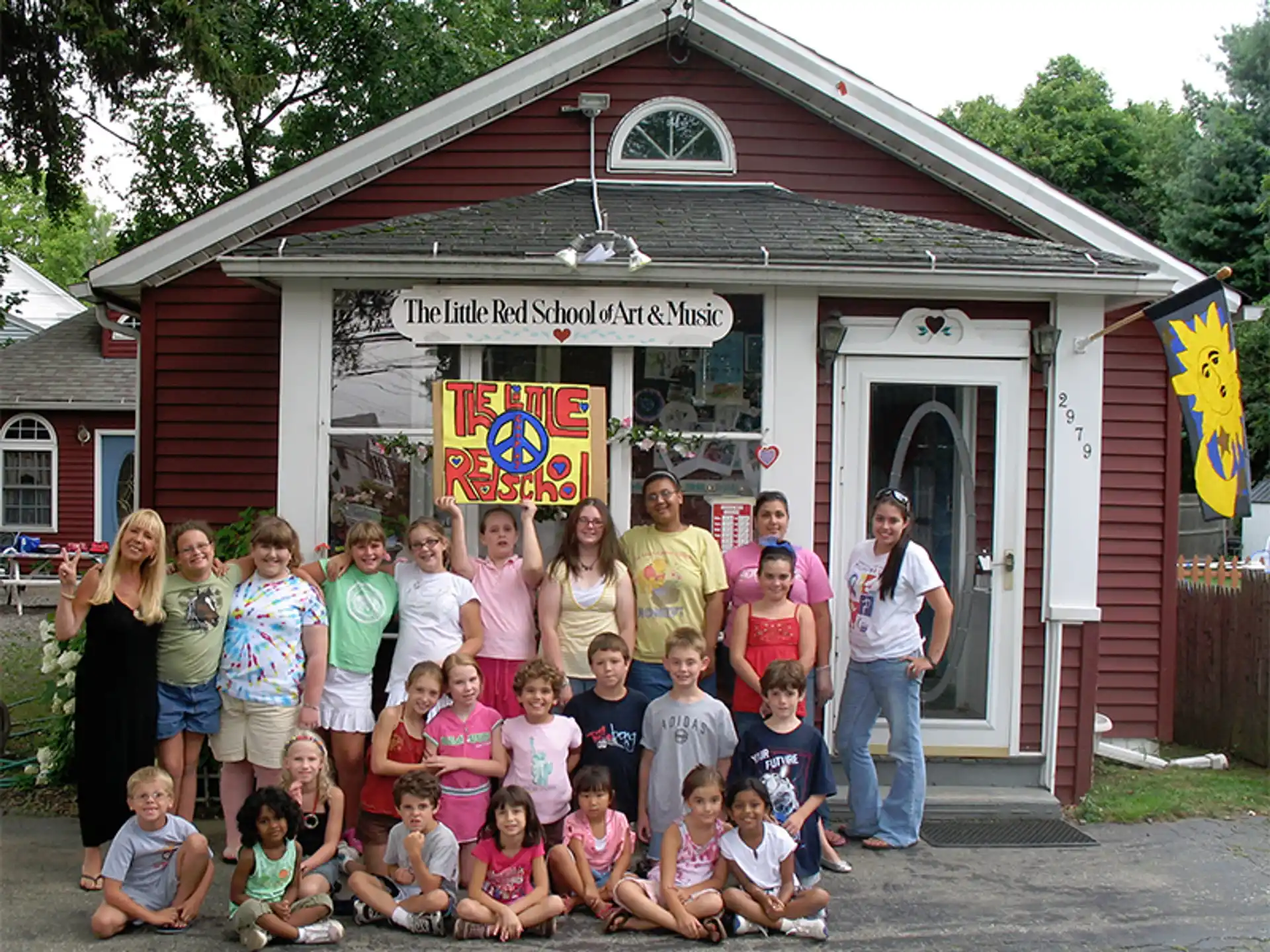 a group of people posing for a photo in front of a building