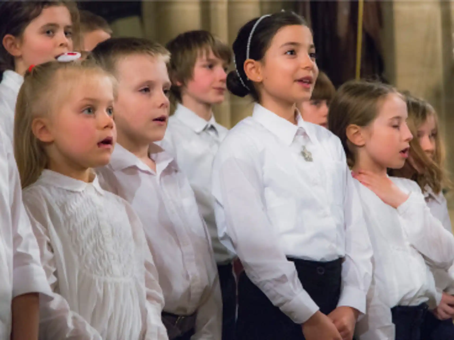 a group of children in white robes