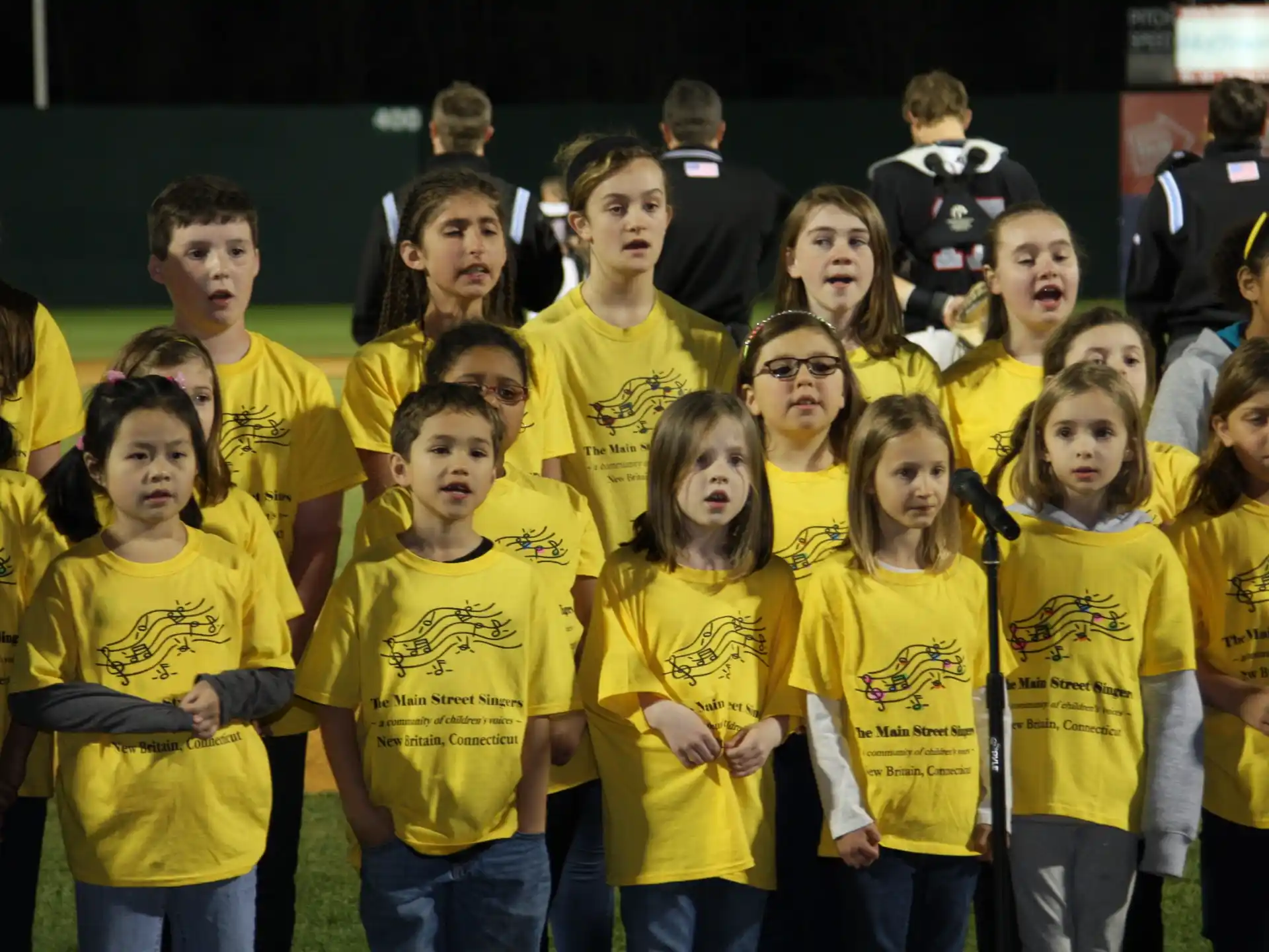 a group of people wearing yellow shirts