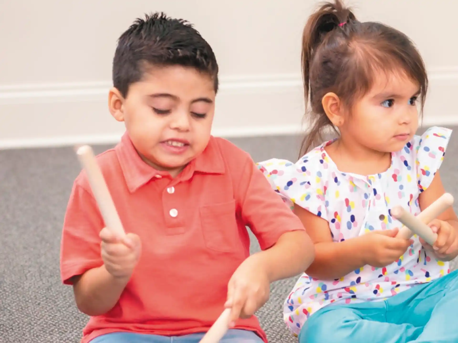 a couple of children holding toothbrushes