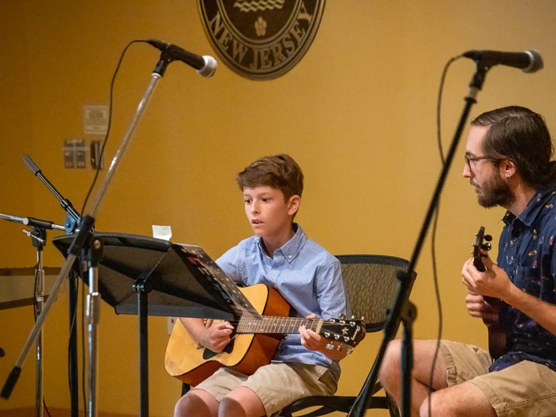 a couple of men playing guitars