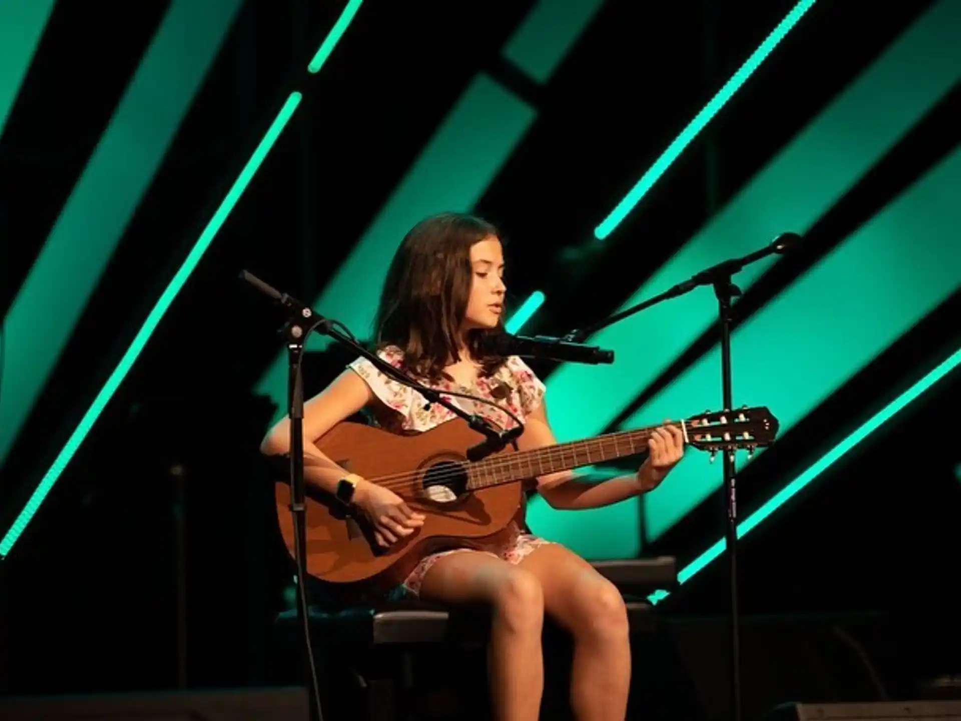 a person playing a guitar on a stage
