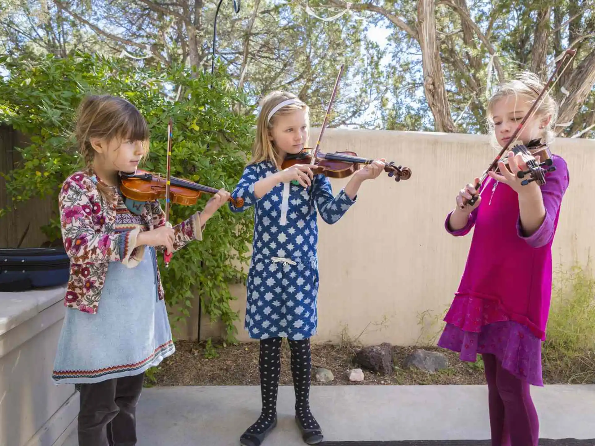 a group of girls playing violin