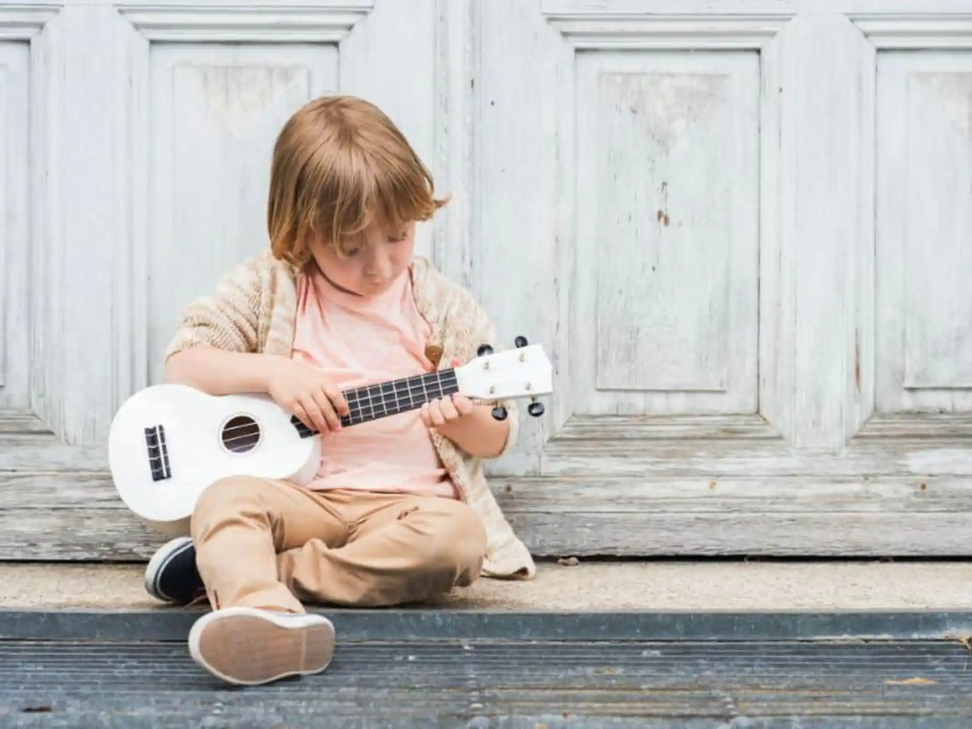 a child playing a guitar