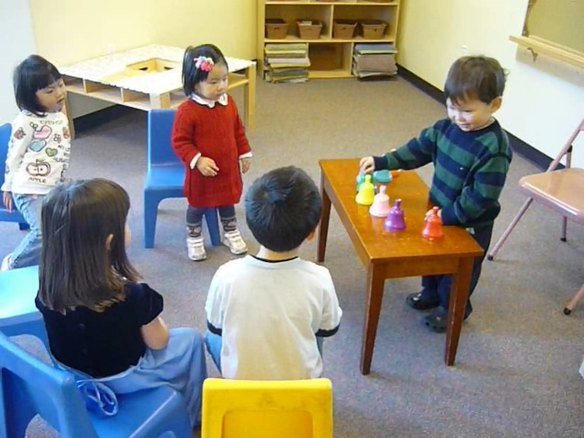 a group of children sitting at desks in a classroom