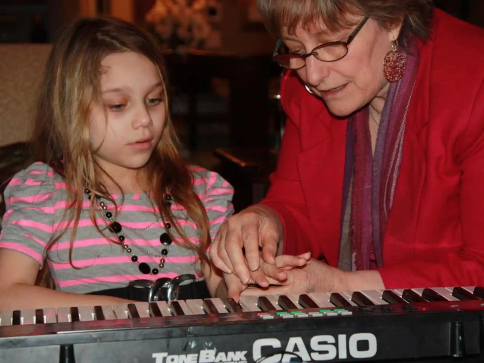 a person and a girl playing a piano