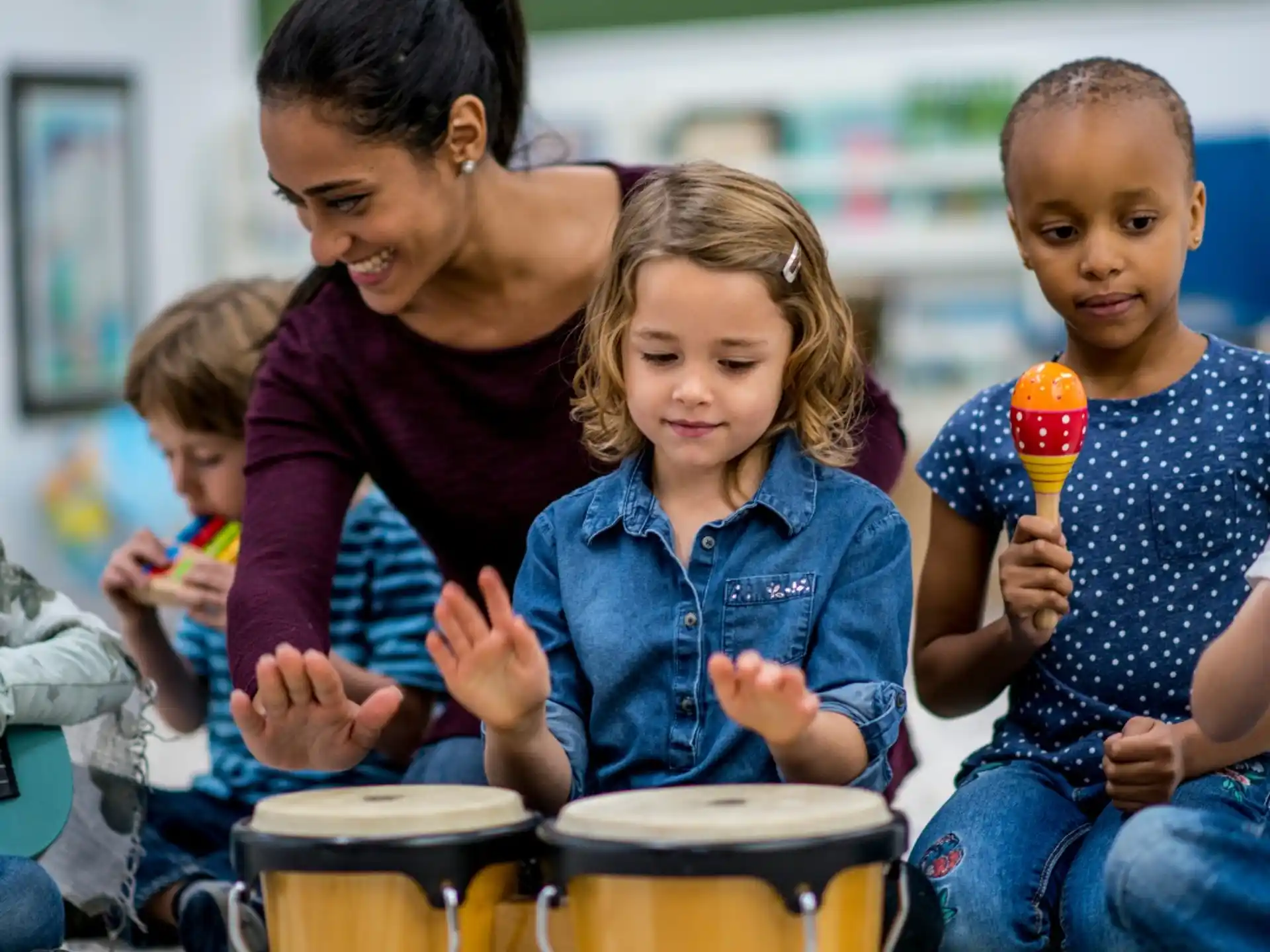 a person and two children playing drums