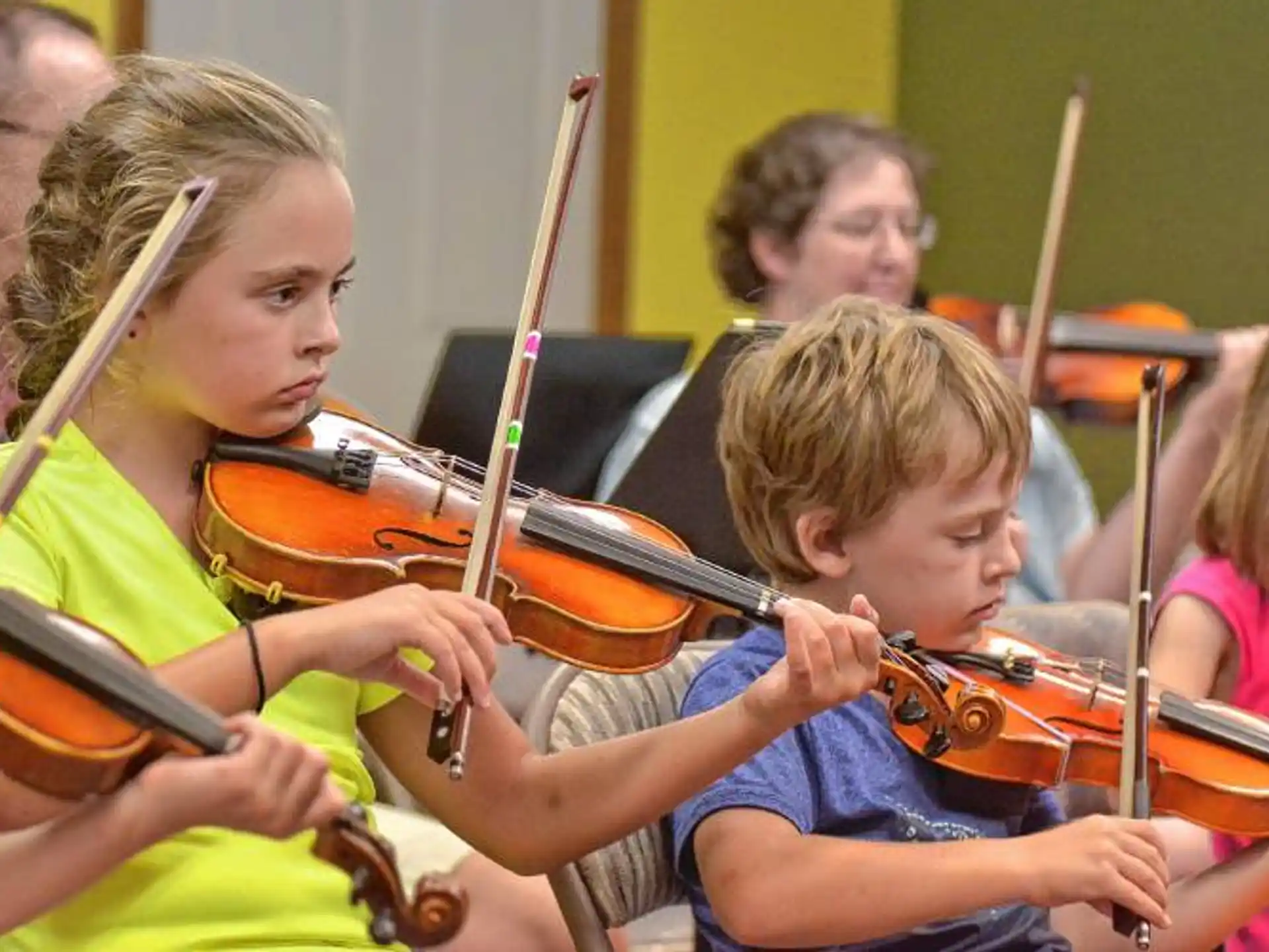 a group of kids playing violin