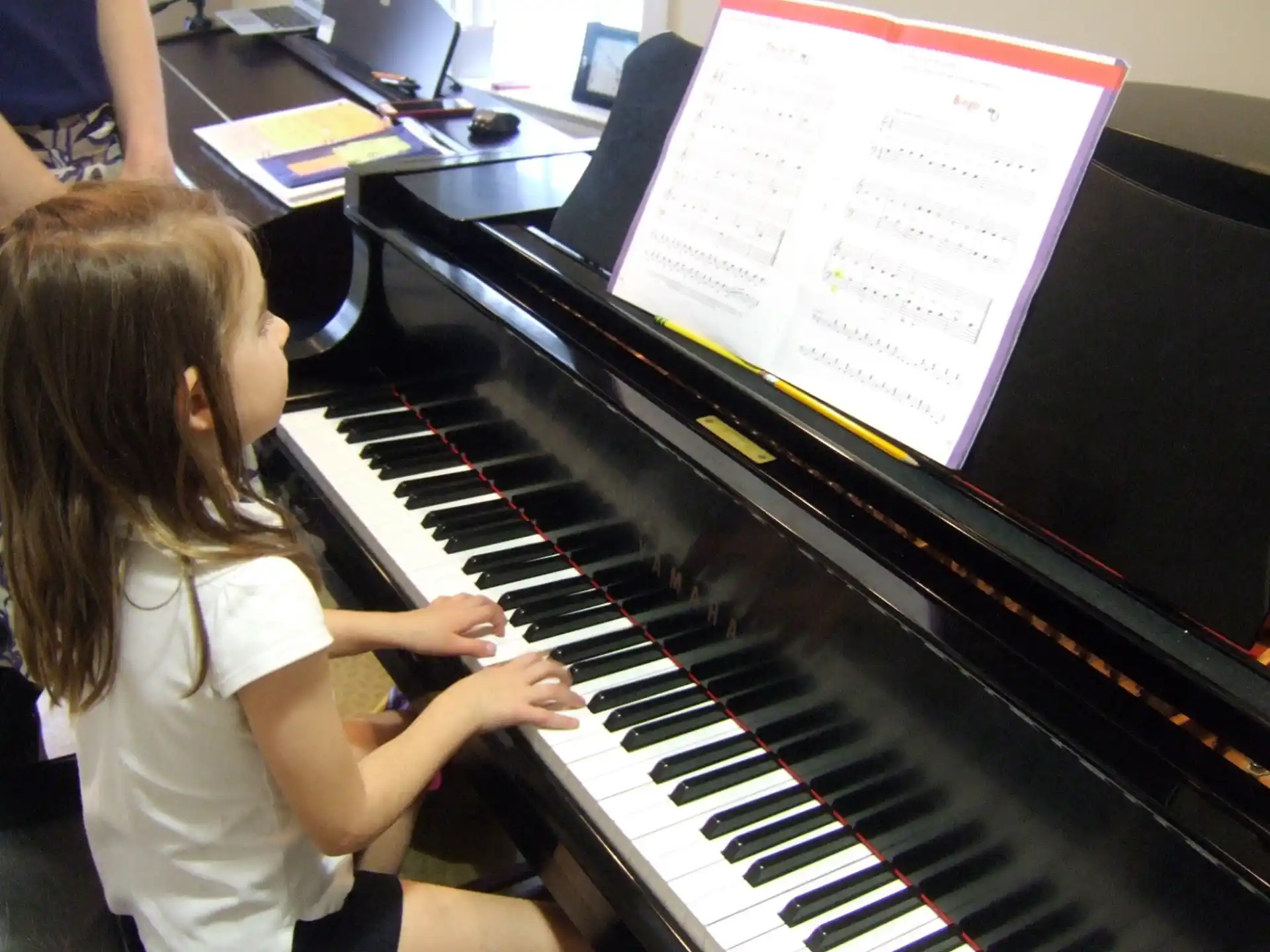 a girl playing a piano
