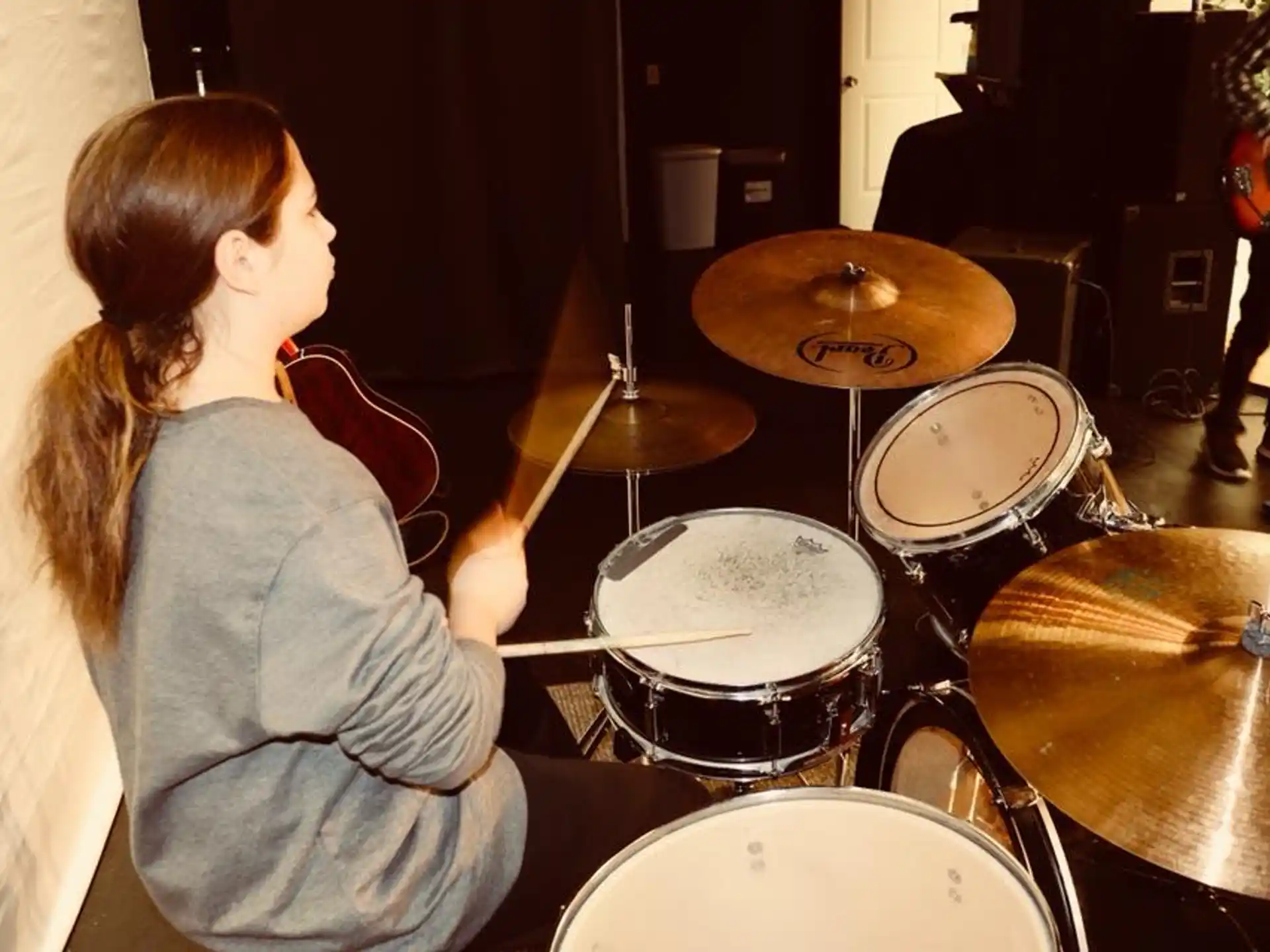a woman playing the drums