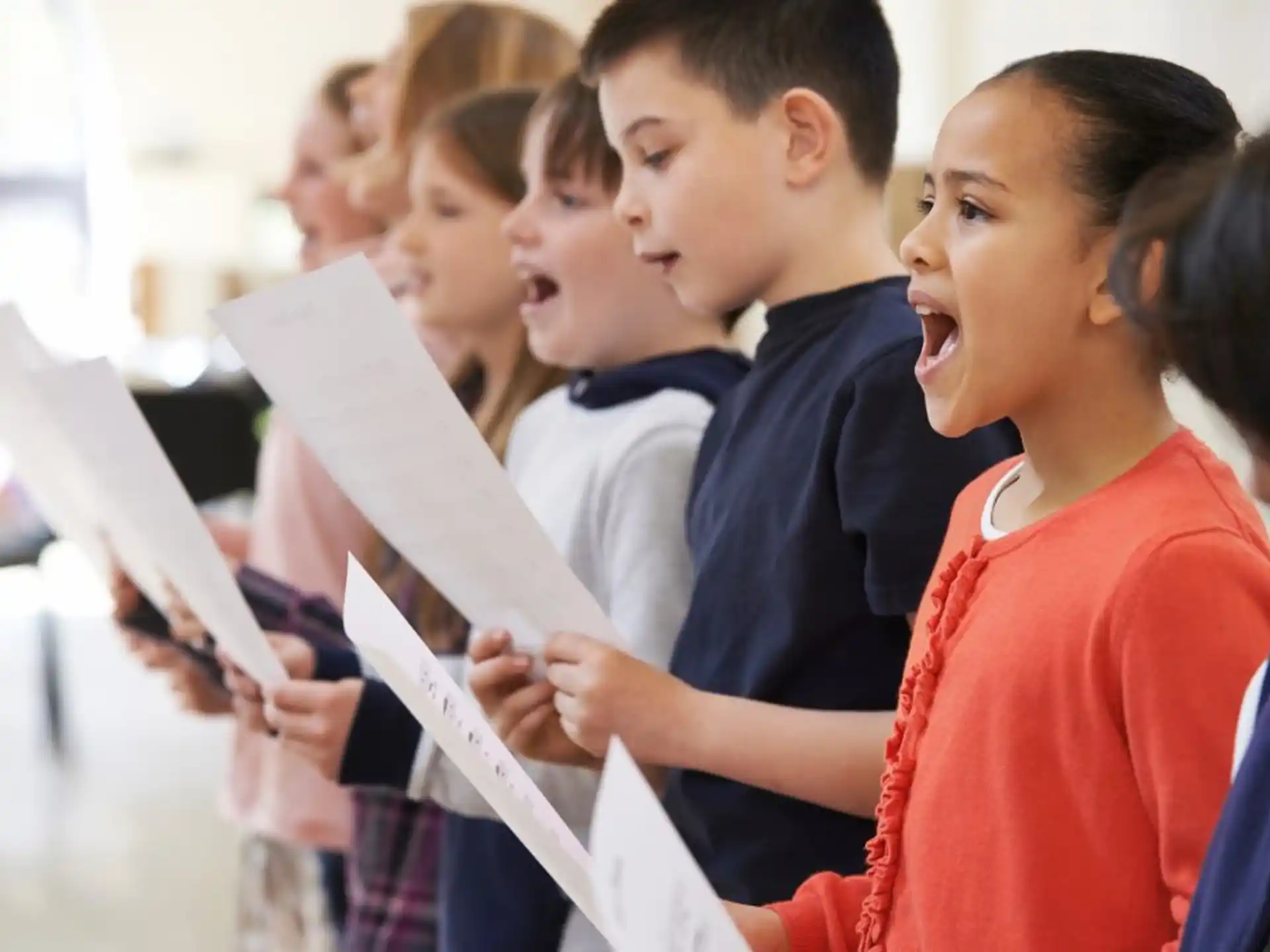 a group of children looking at a paper
