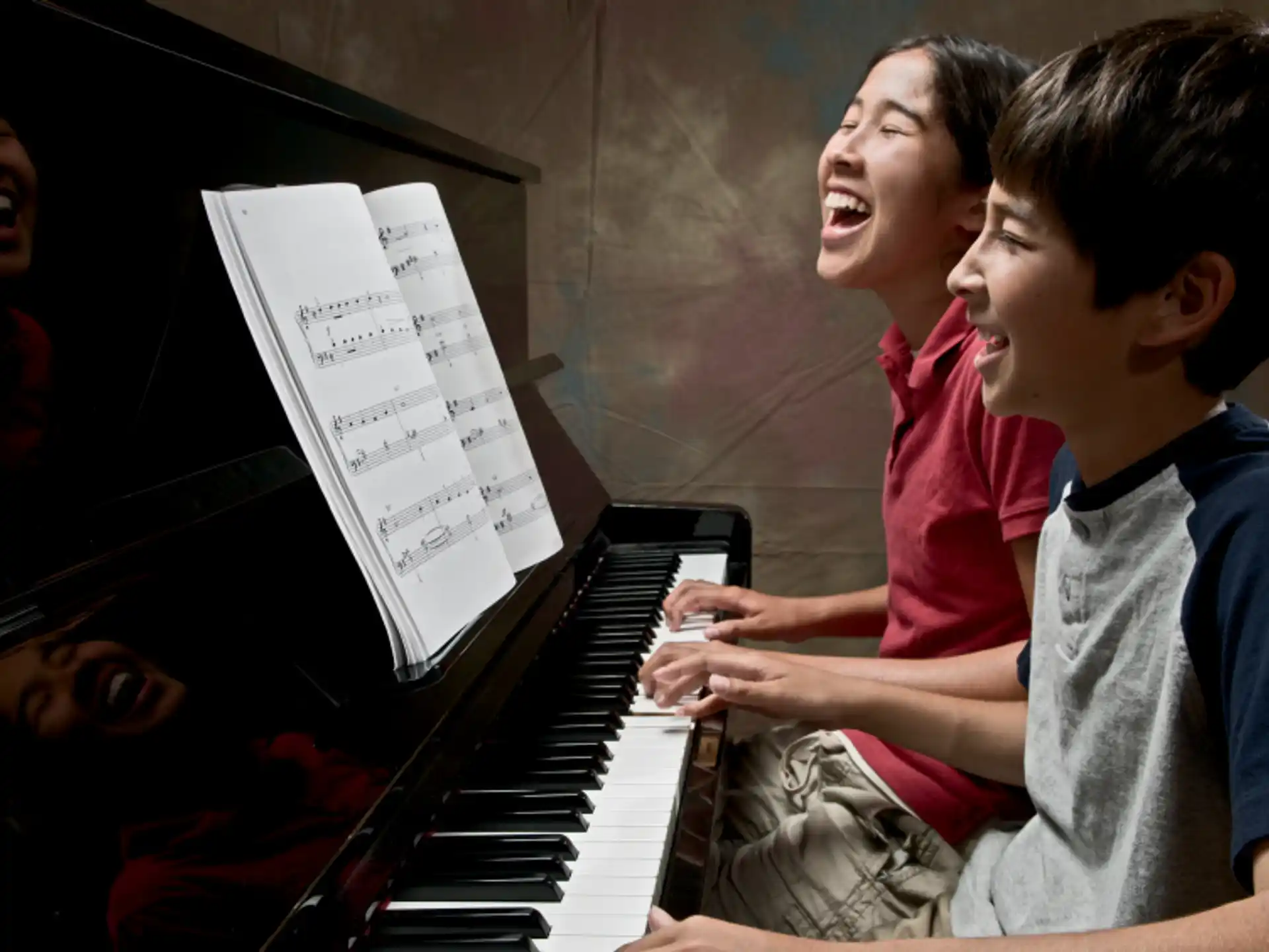 a boy playing a piano