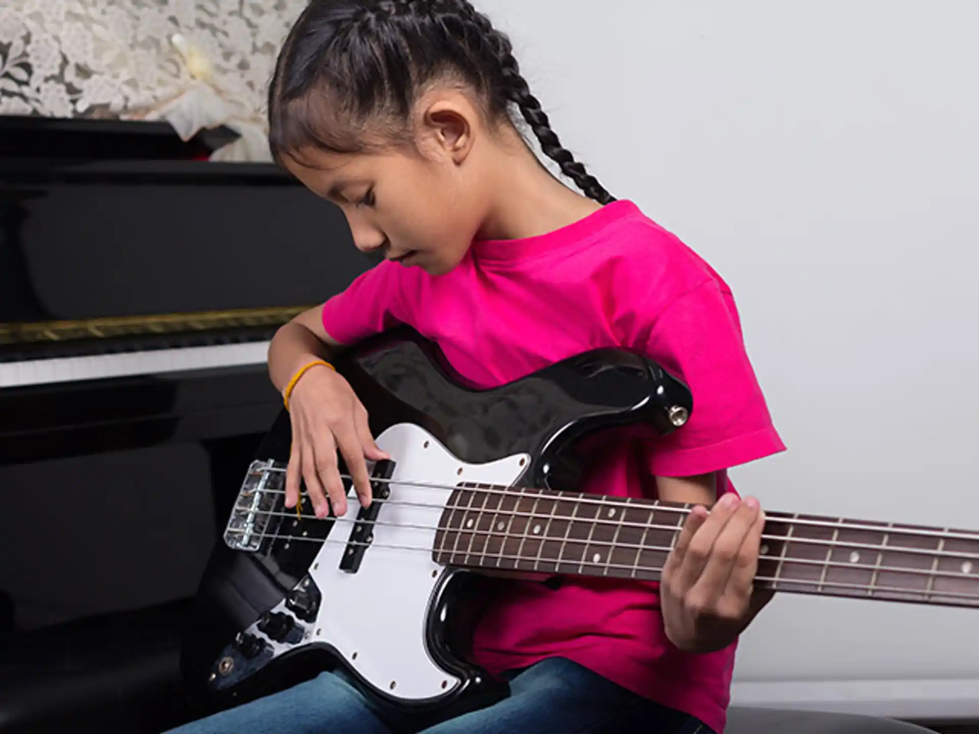 a young girl playing a guitar