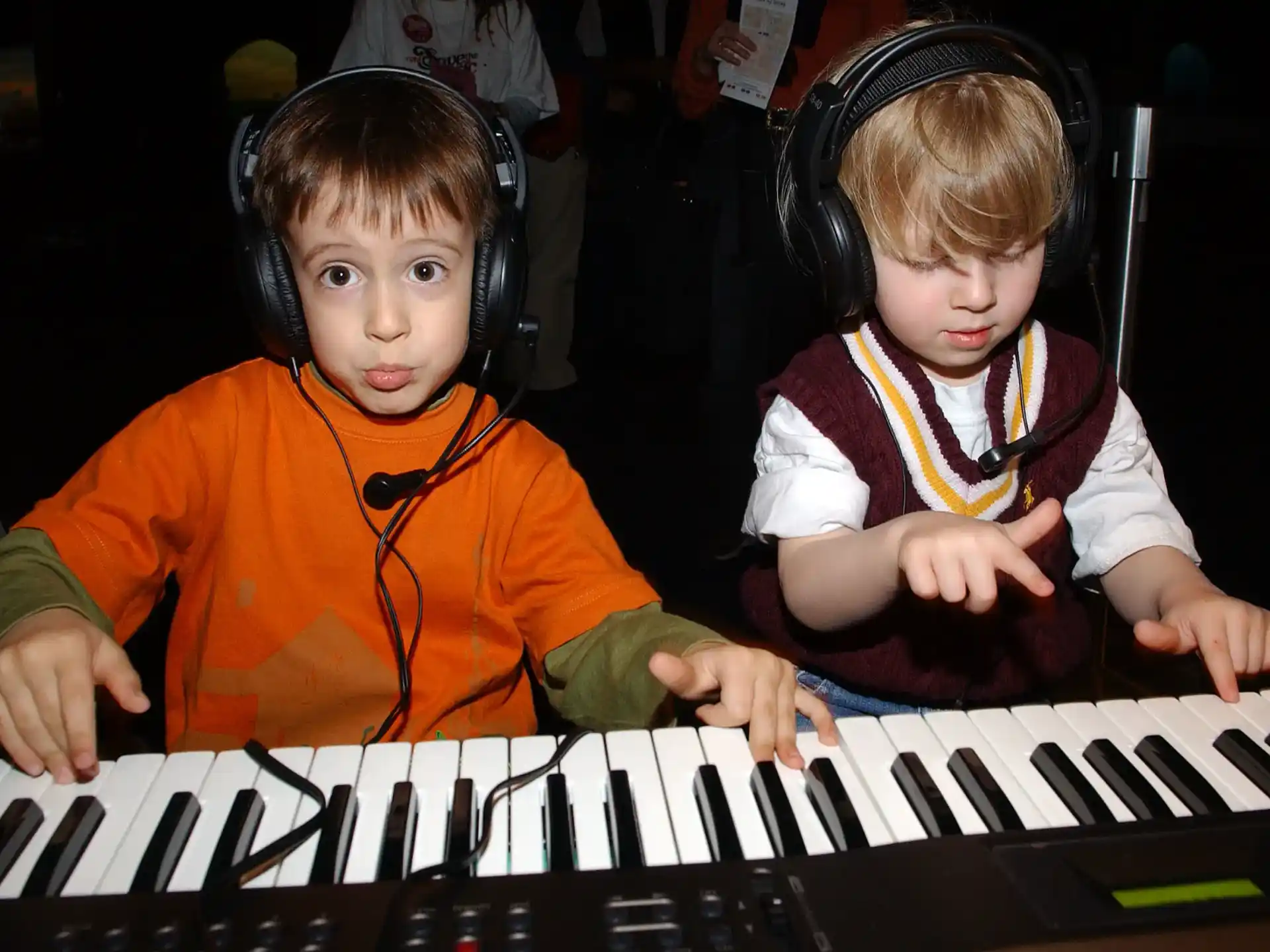 two children playing a piano