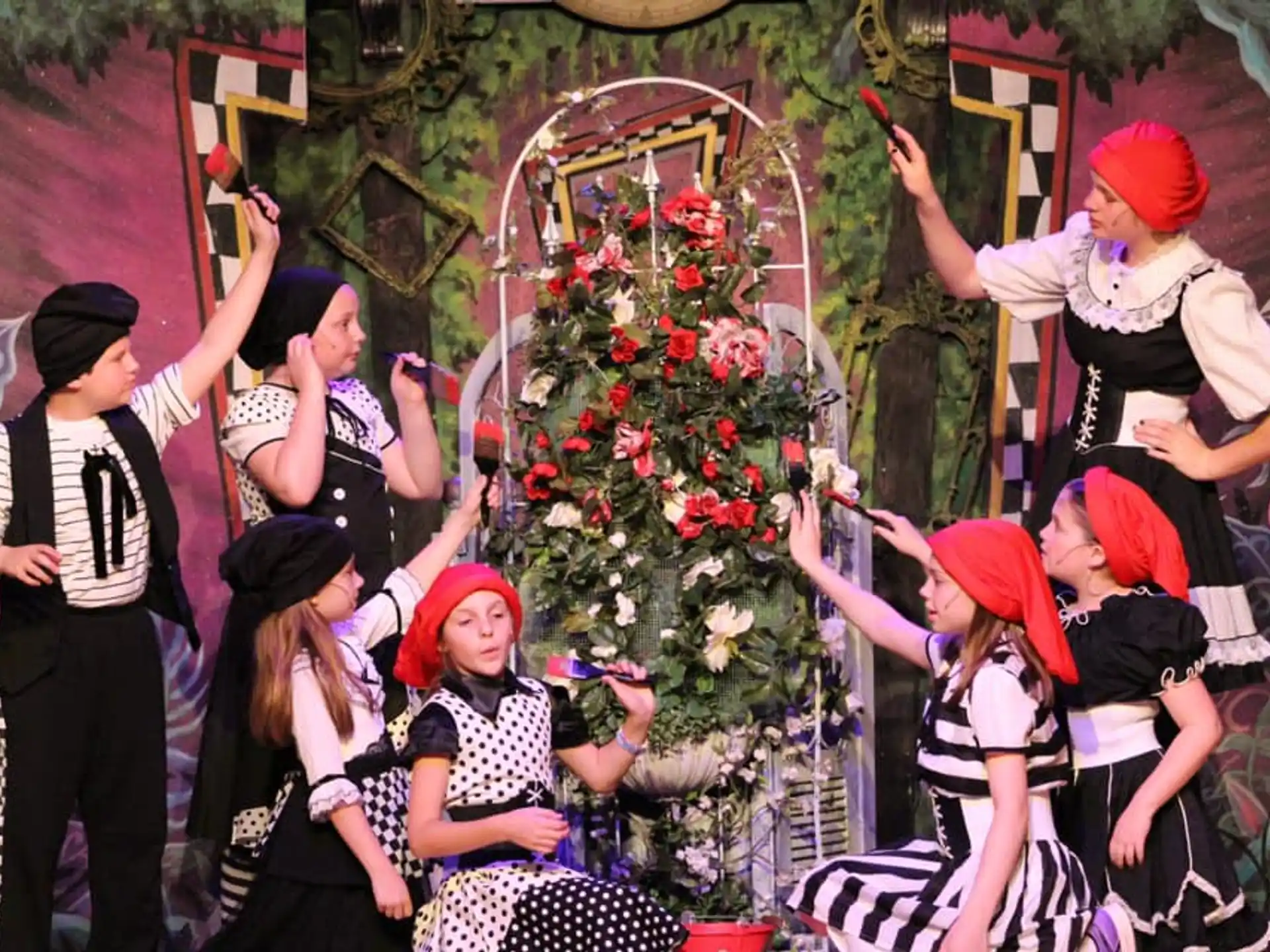 a group of people around a decorated tree
