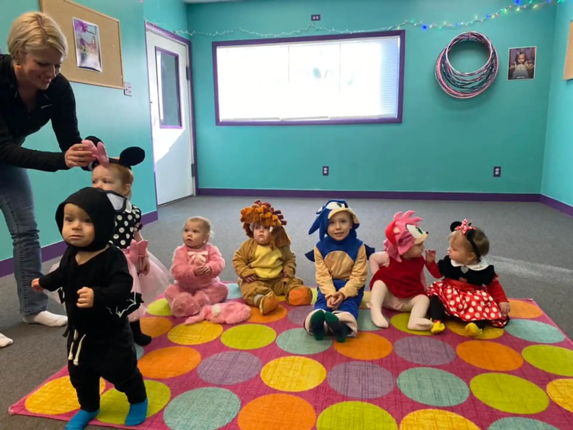 a group of children sitting on the floor in a room