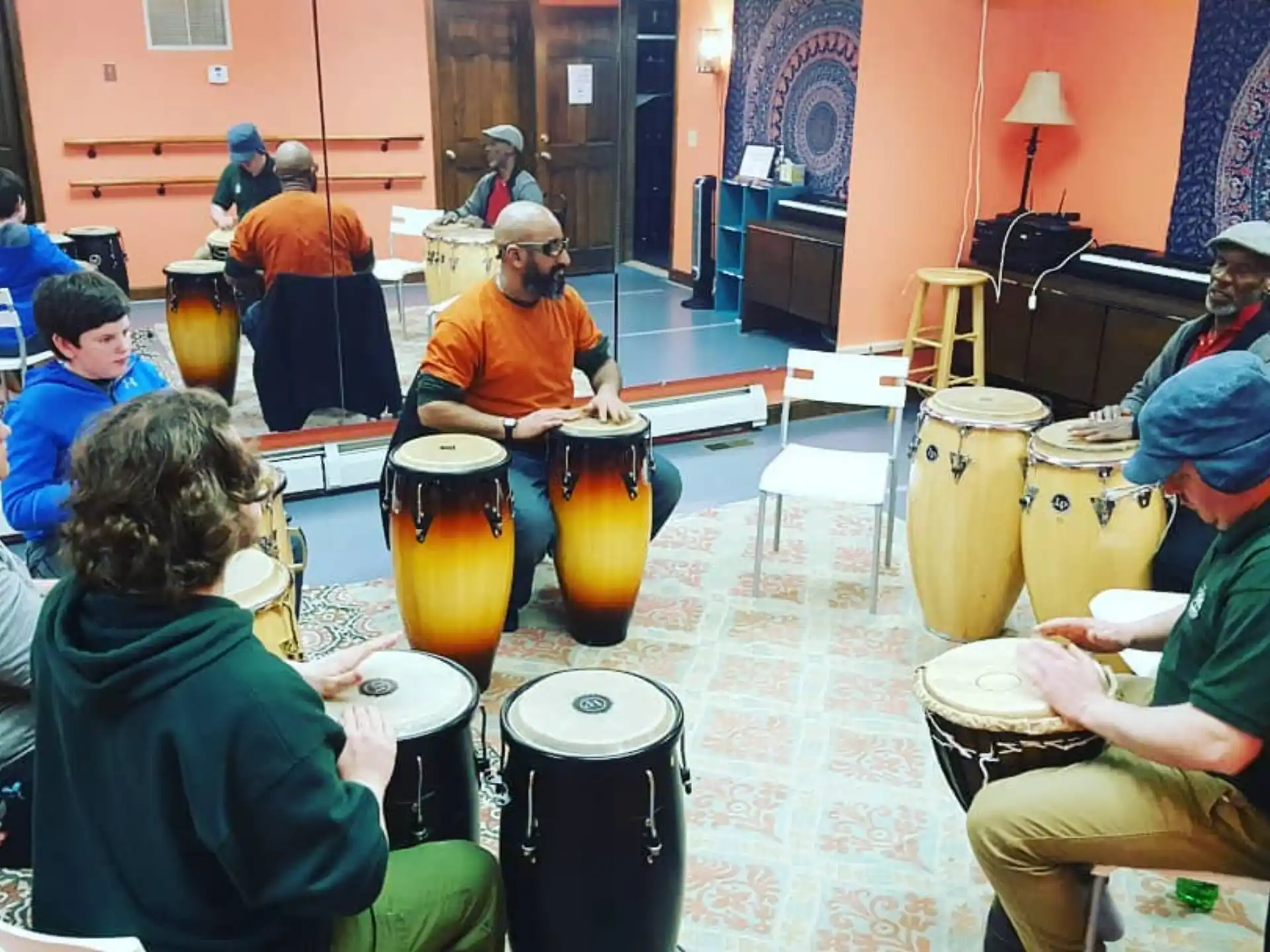 a group of people sitting around a table with large vases