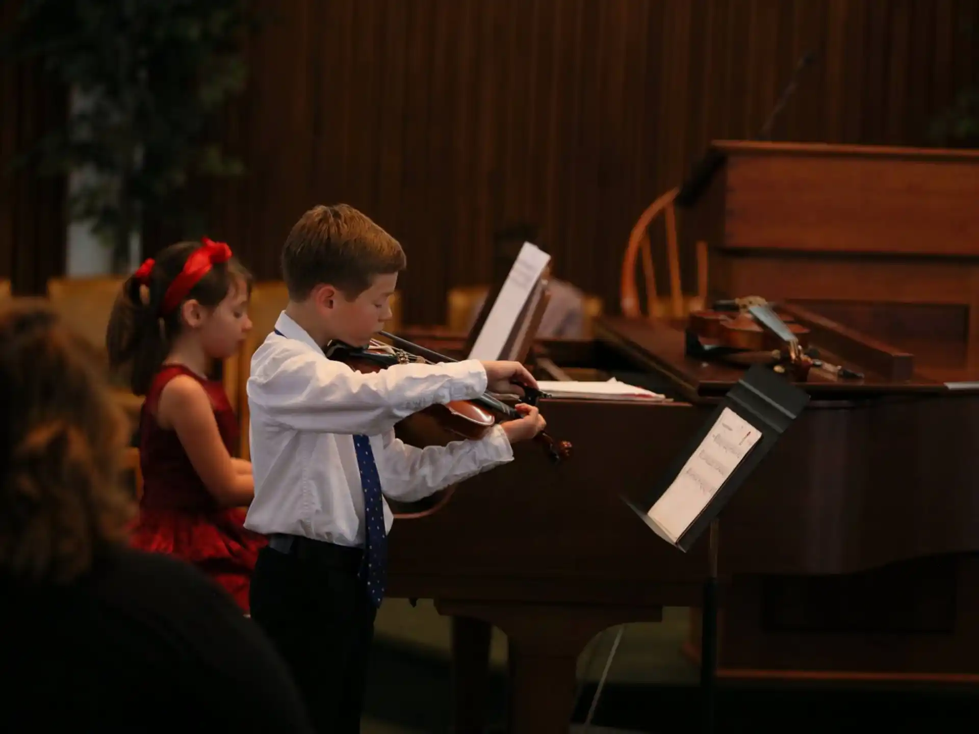 a boy playing a piano