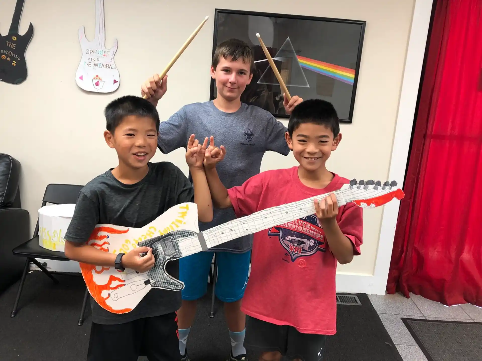 a group of boys holding a large red and white object