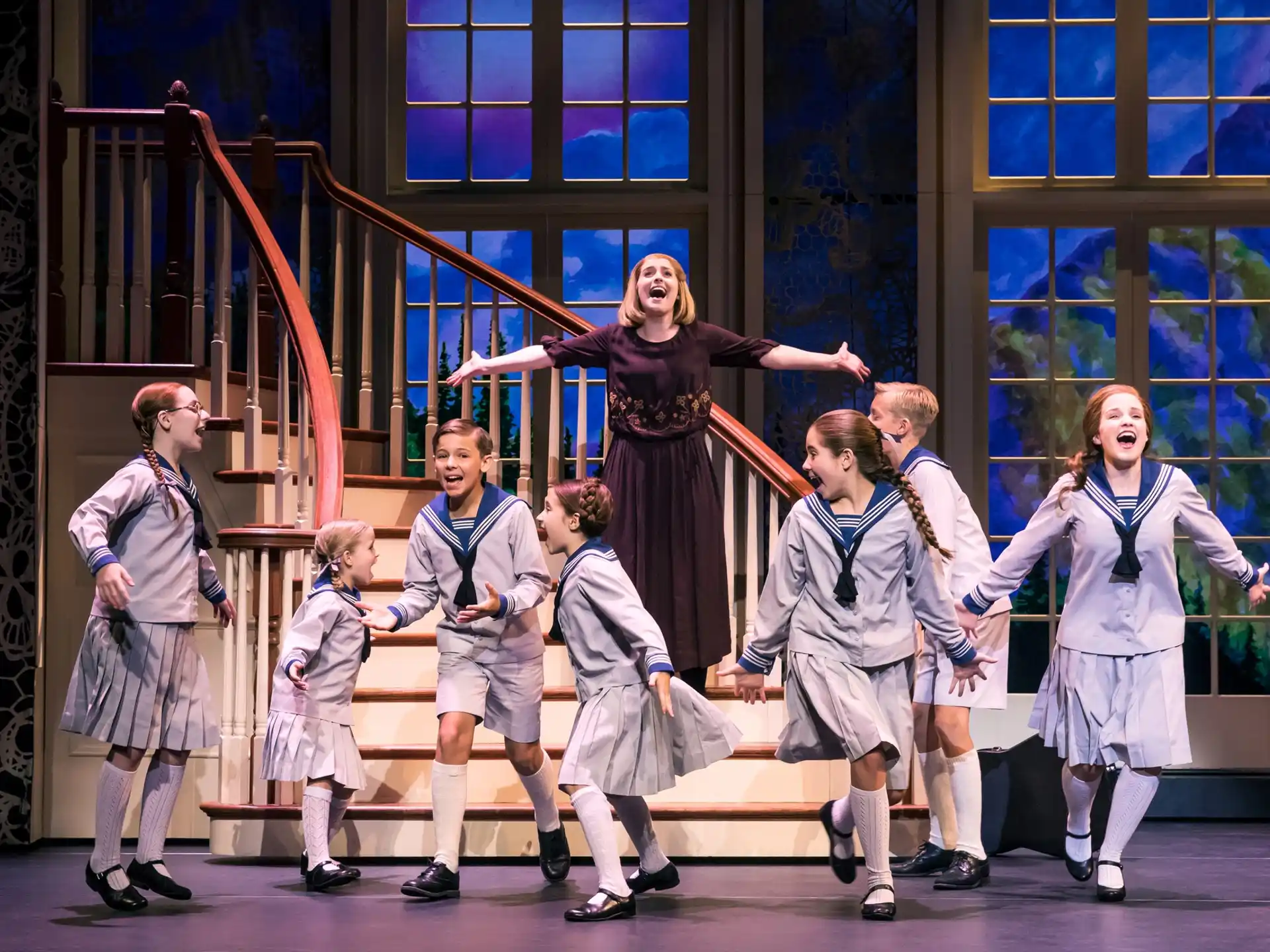 a group of children performing on a stage