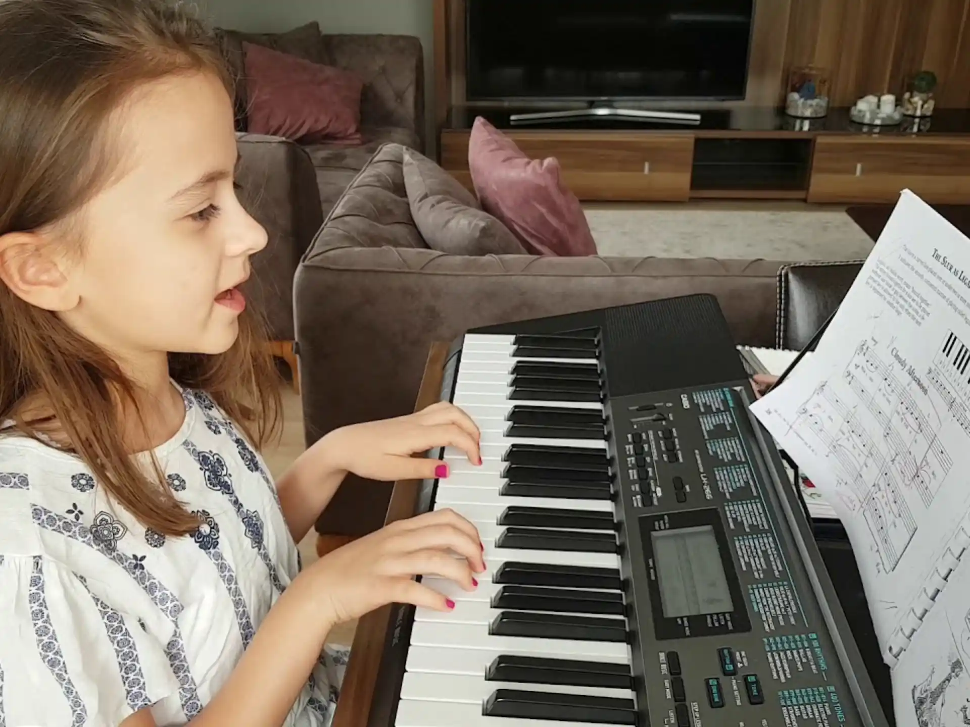 a girl playing a piano