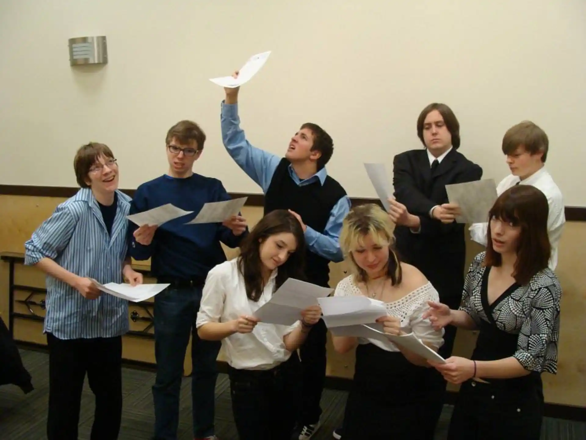 a group of people holding papers