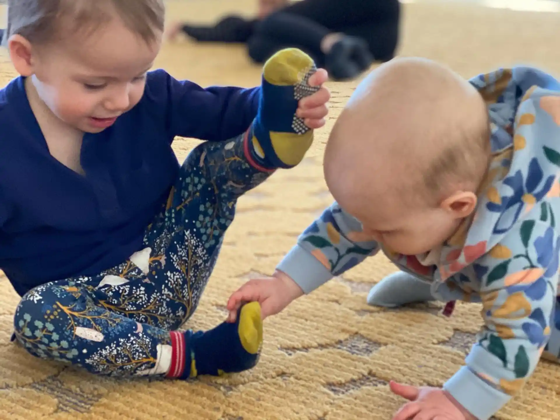 a couple of young boys playing with a toy