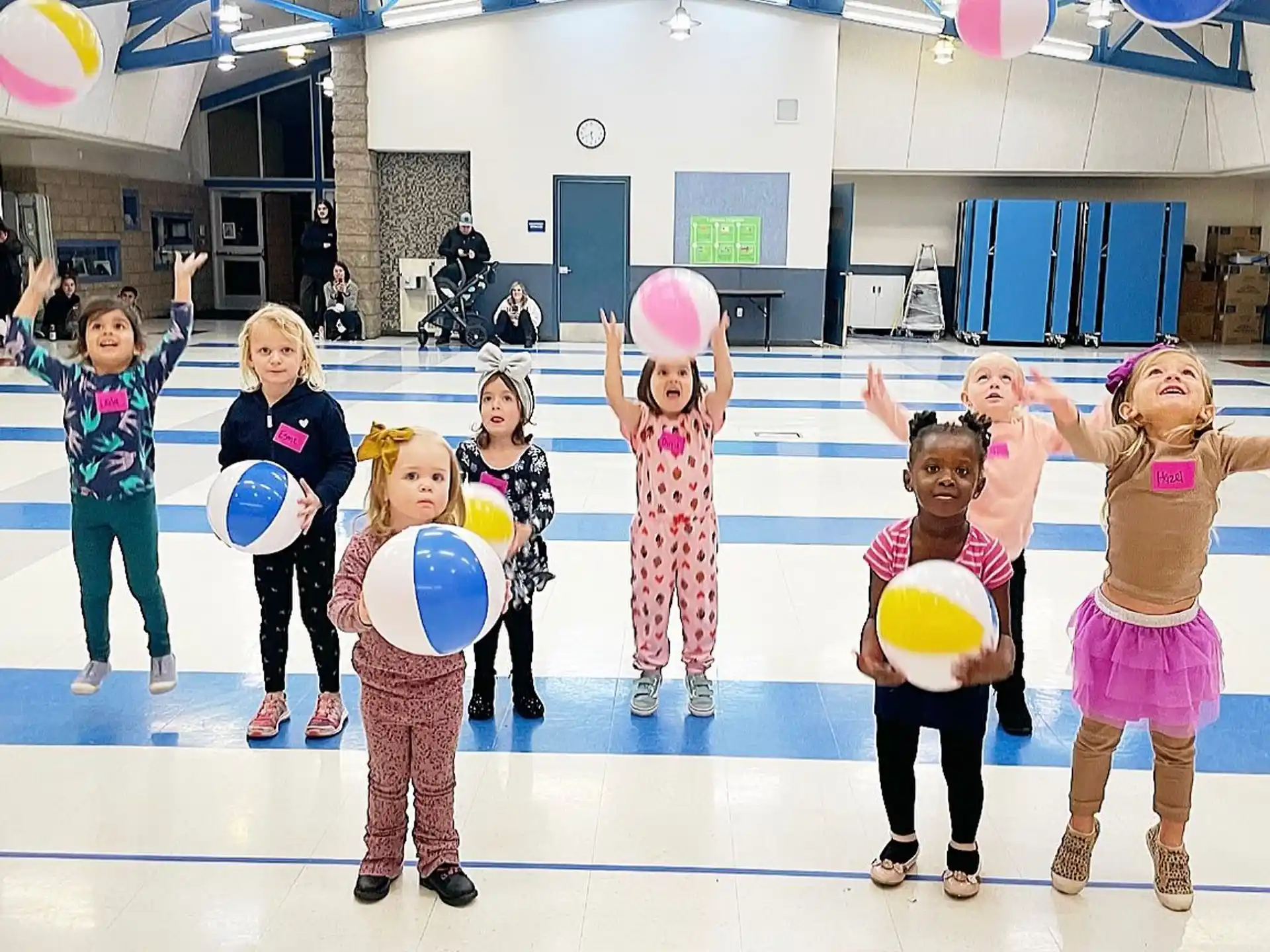 a group of children holding balloons
