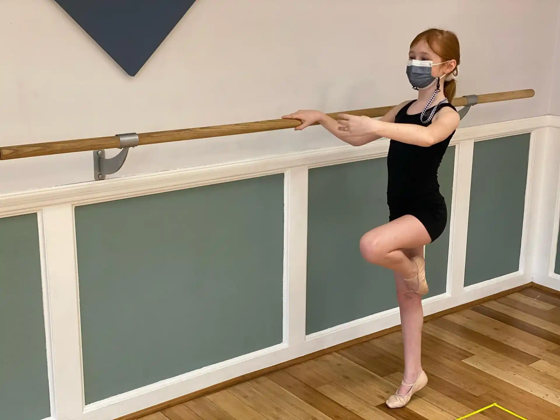 a person wearing a mask and standing on a bar