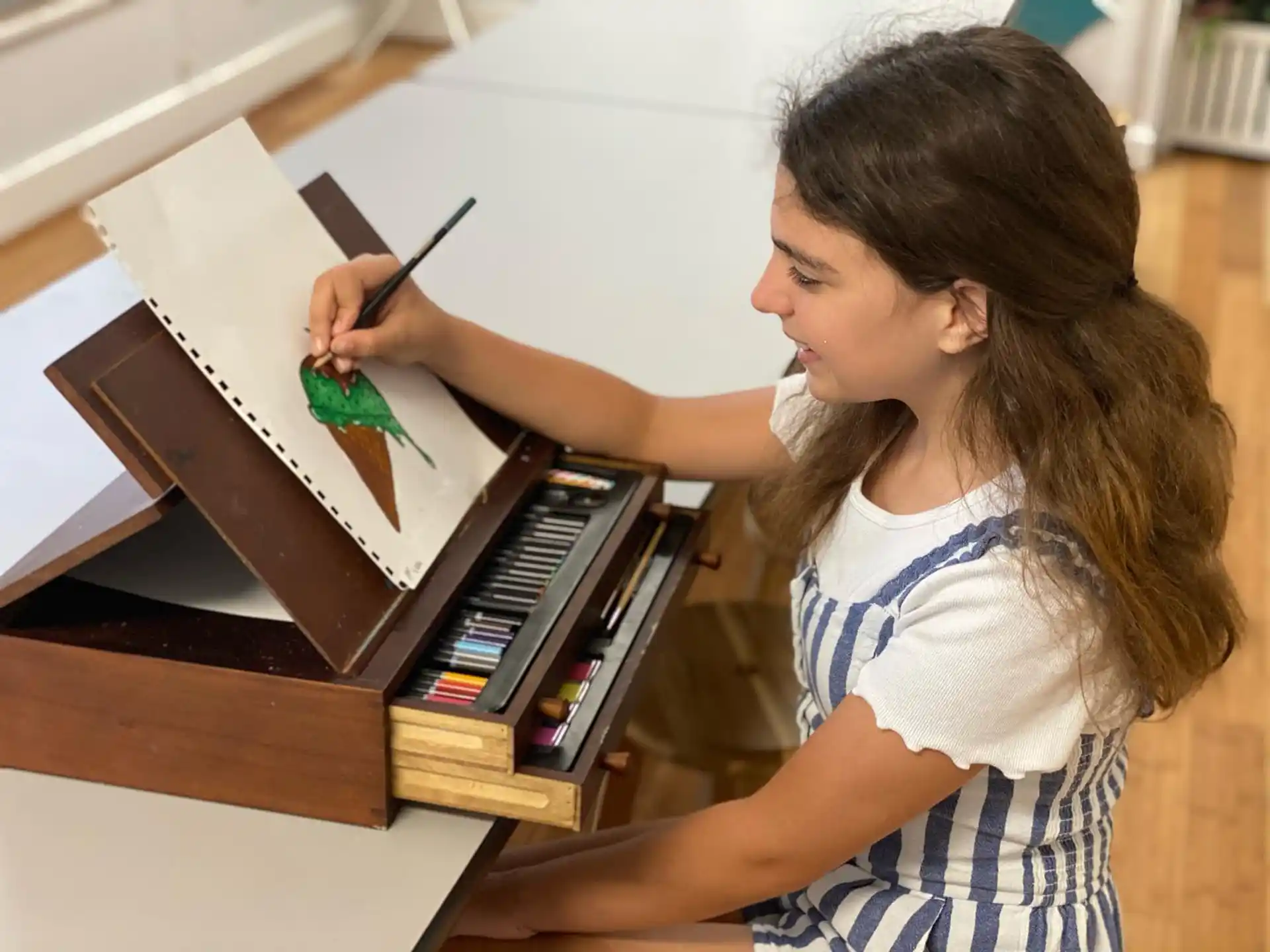 a young girl writing on a book