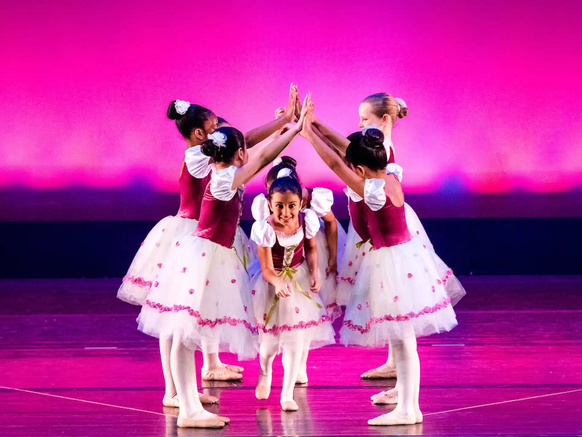a group of women dancing on a stage