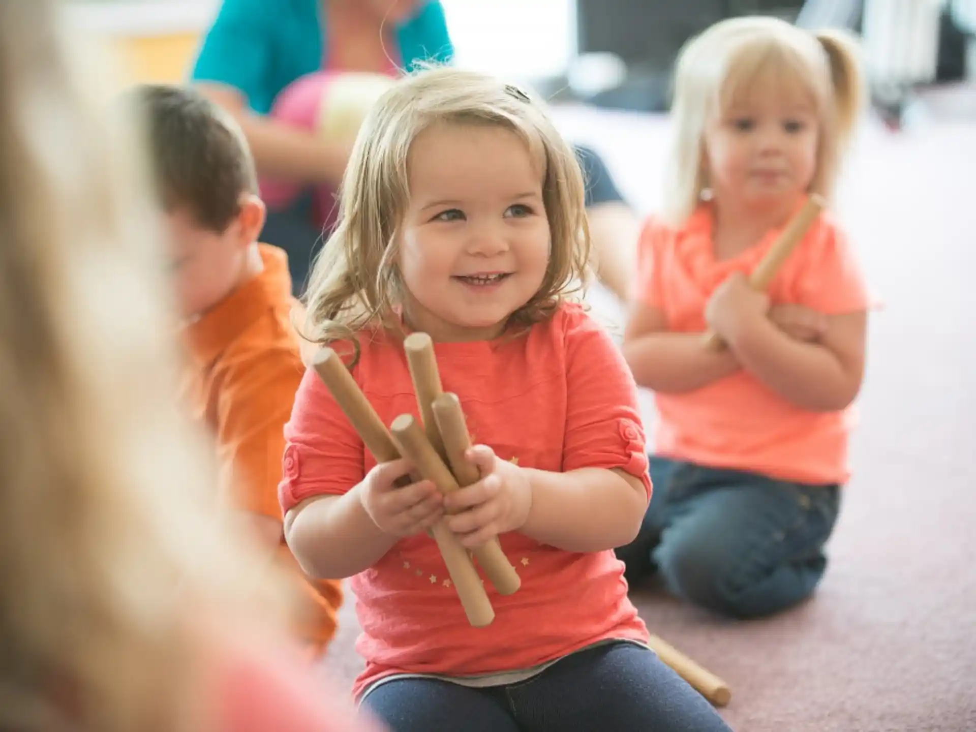 a group of children holding pencils