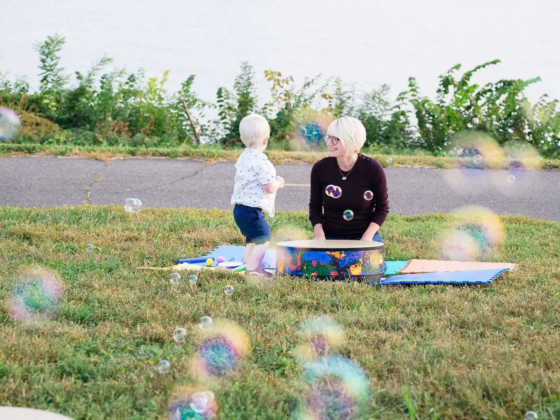 a person and a child playing on a picnic table