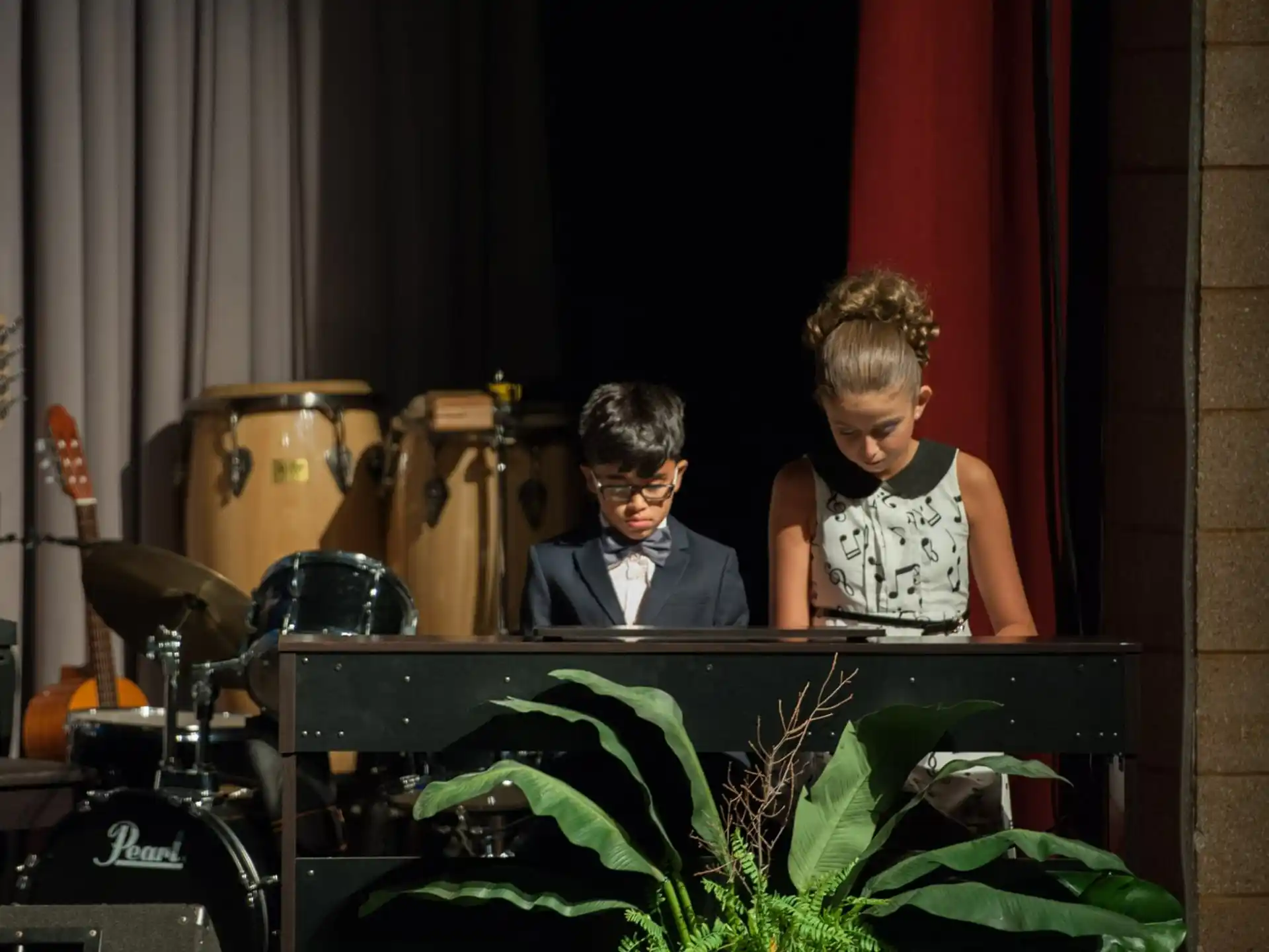 a man and a woman playing the piano