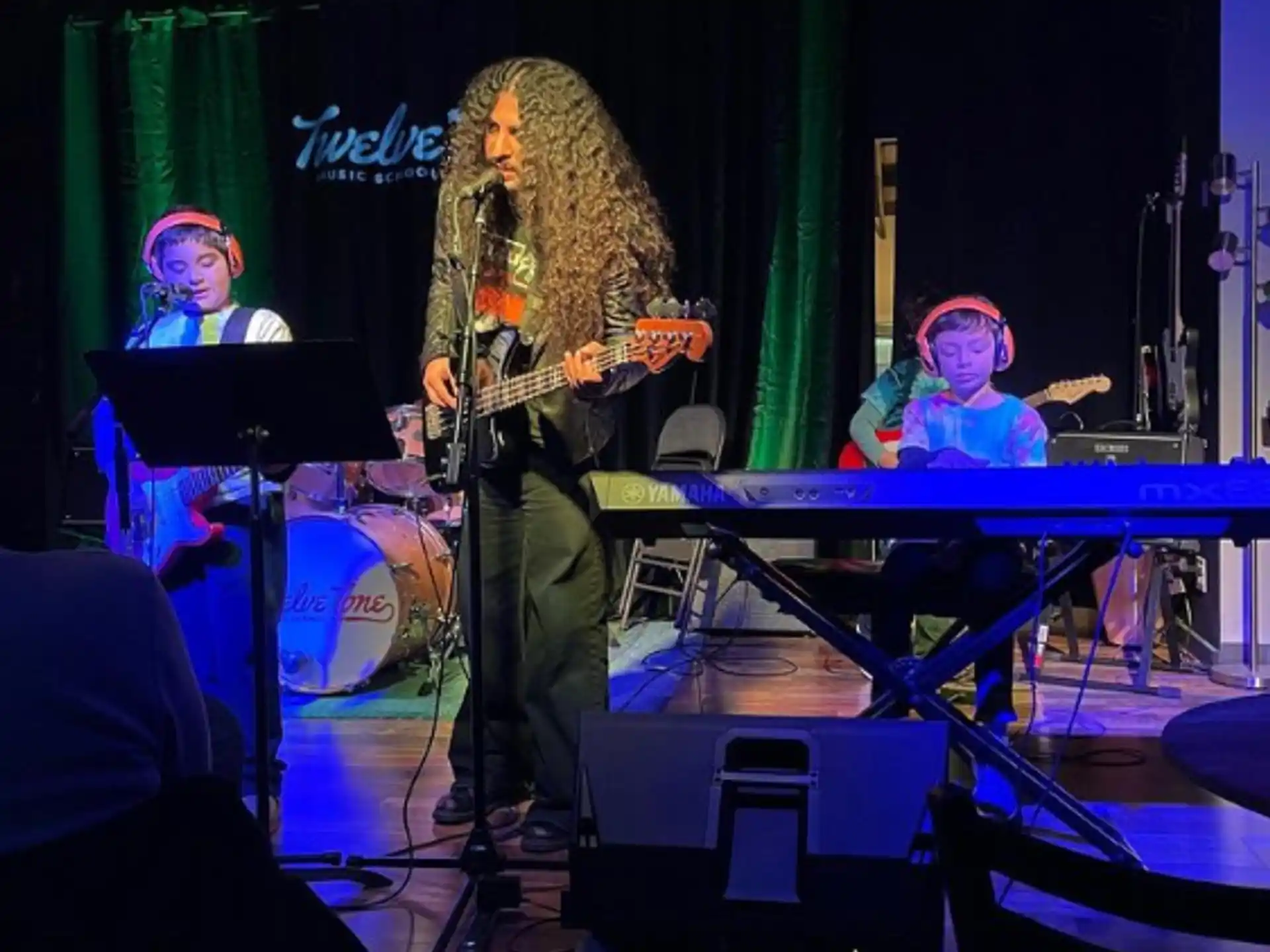 a group of people playing instruments on a stage