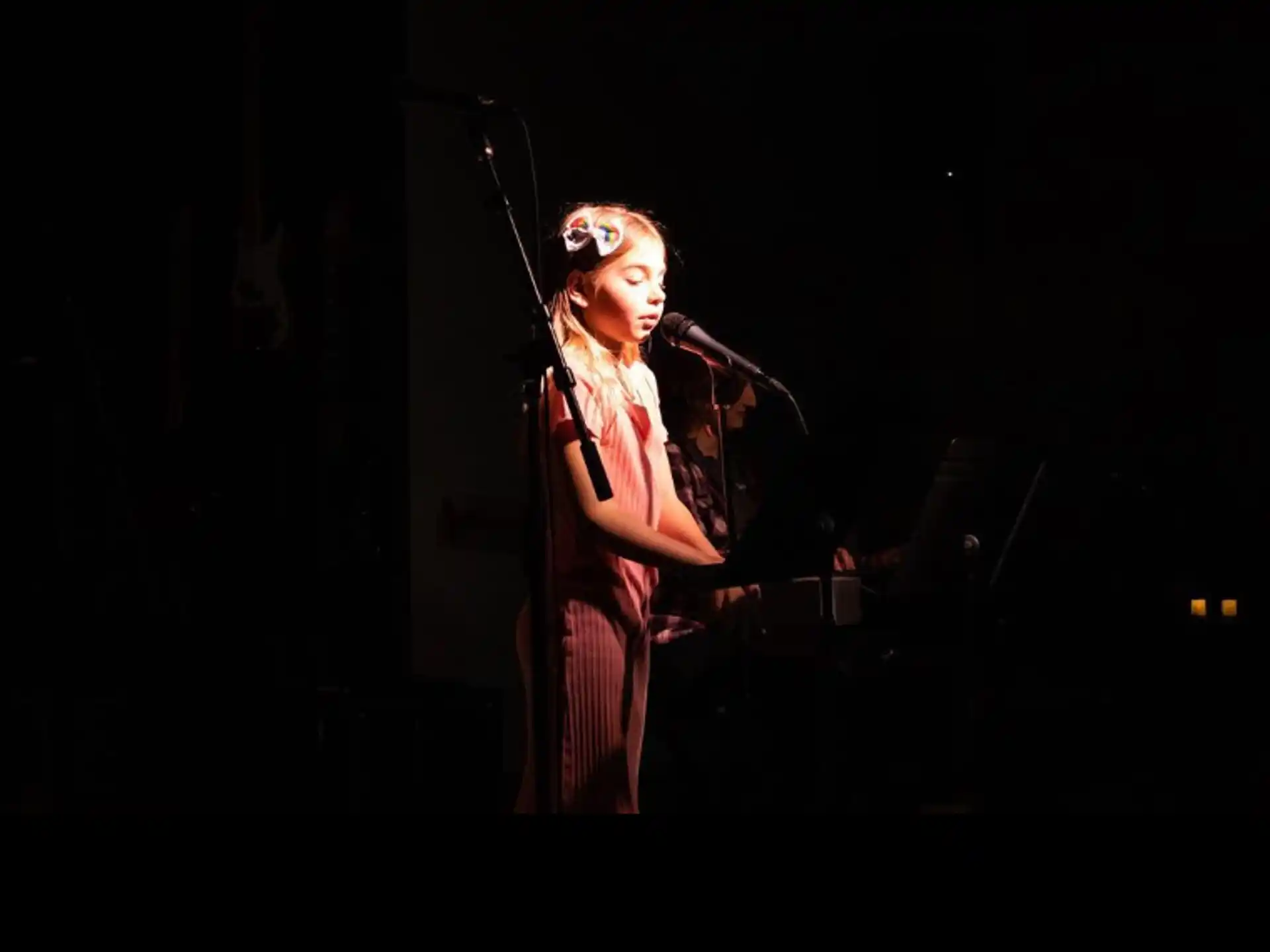 a person singing into a microphone