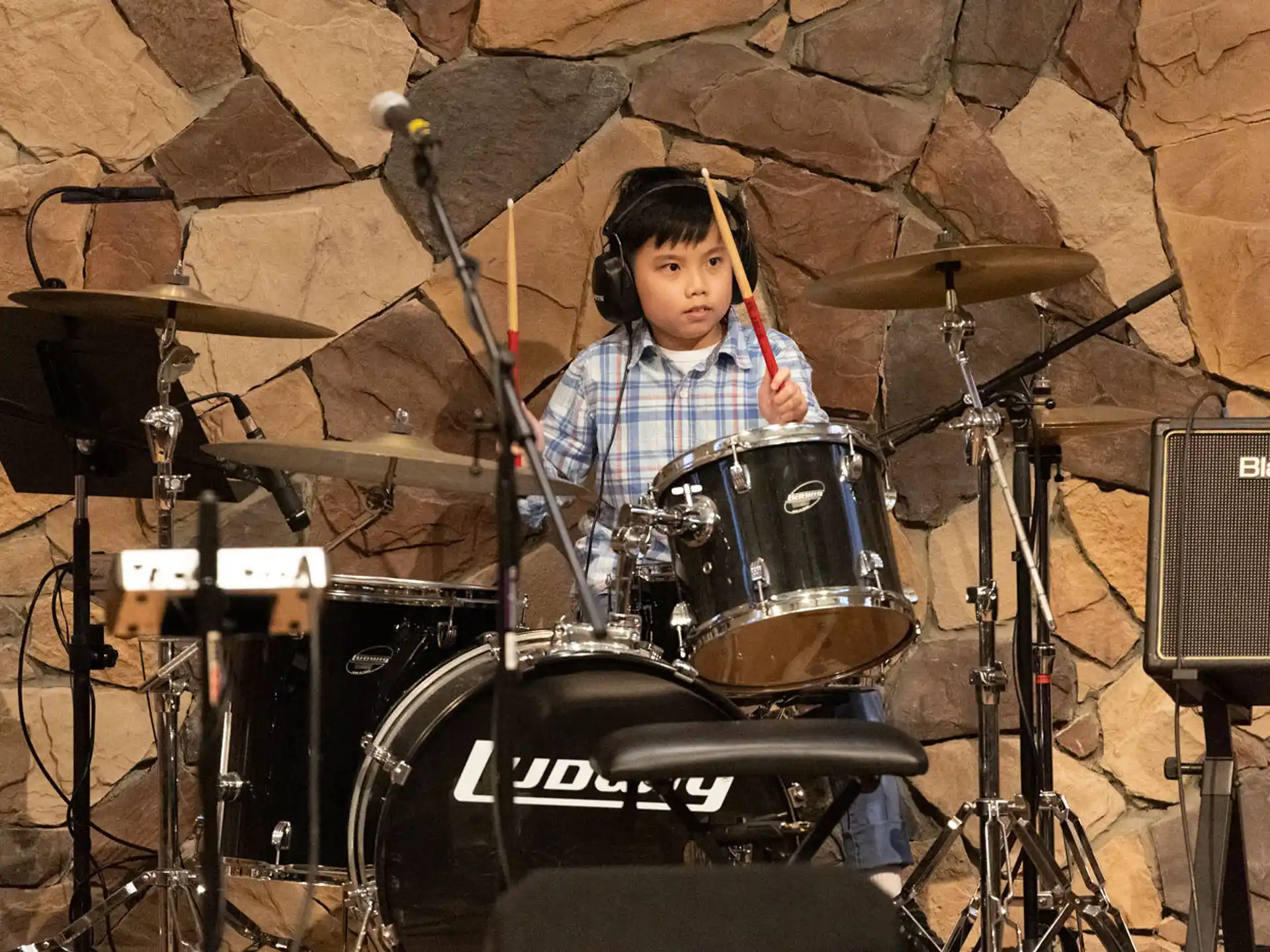 a boy playing drums